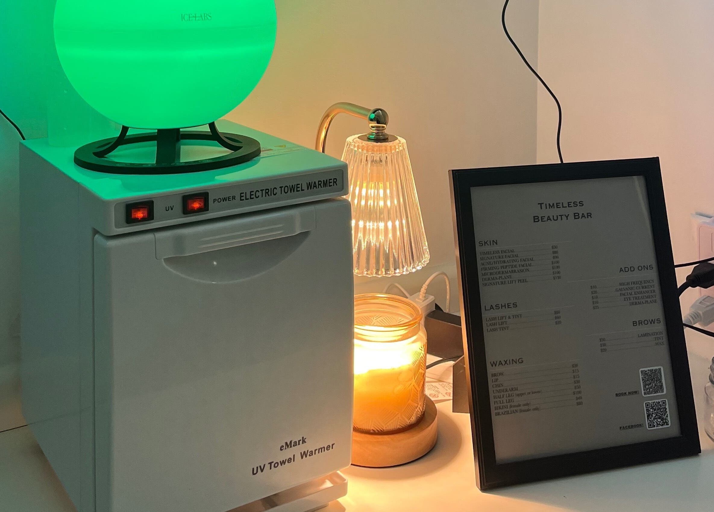 A calming beauty station with towel warmer and menu at Timeless Beauty Bar LLC in Chillicothe, Missouri, US.