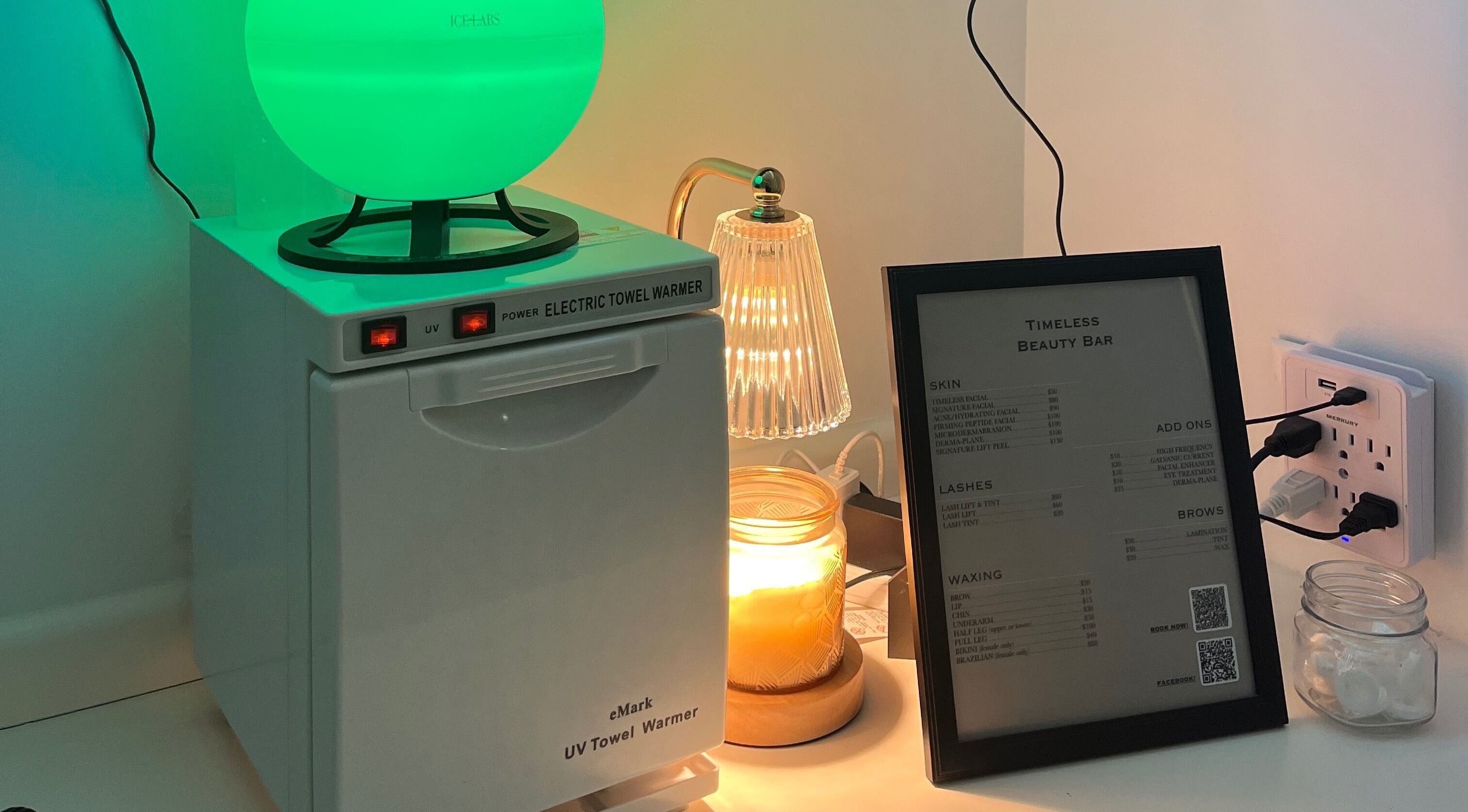 A calming beauty station with towel warmer and menu at Timeless Beauty Bar LLC in Chillicothe, Missouri, US.