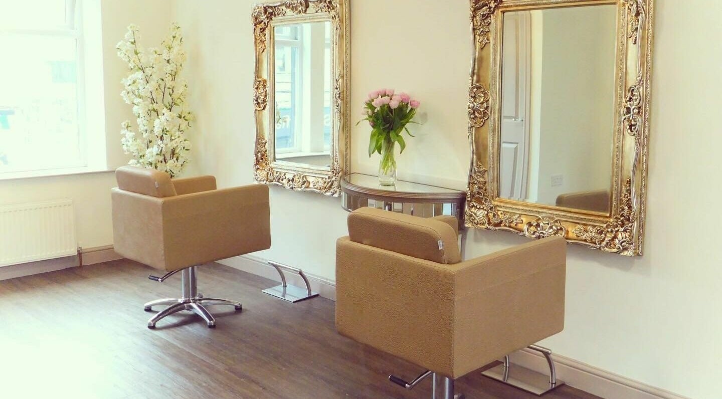 Chic styling area at H and Co Hairdressing, Guiseley, England, GB featuring ornate mirrors and floral decor.
