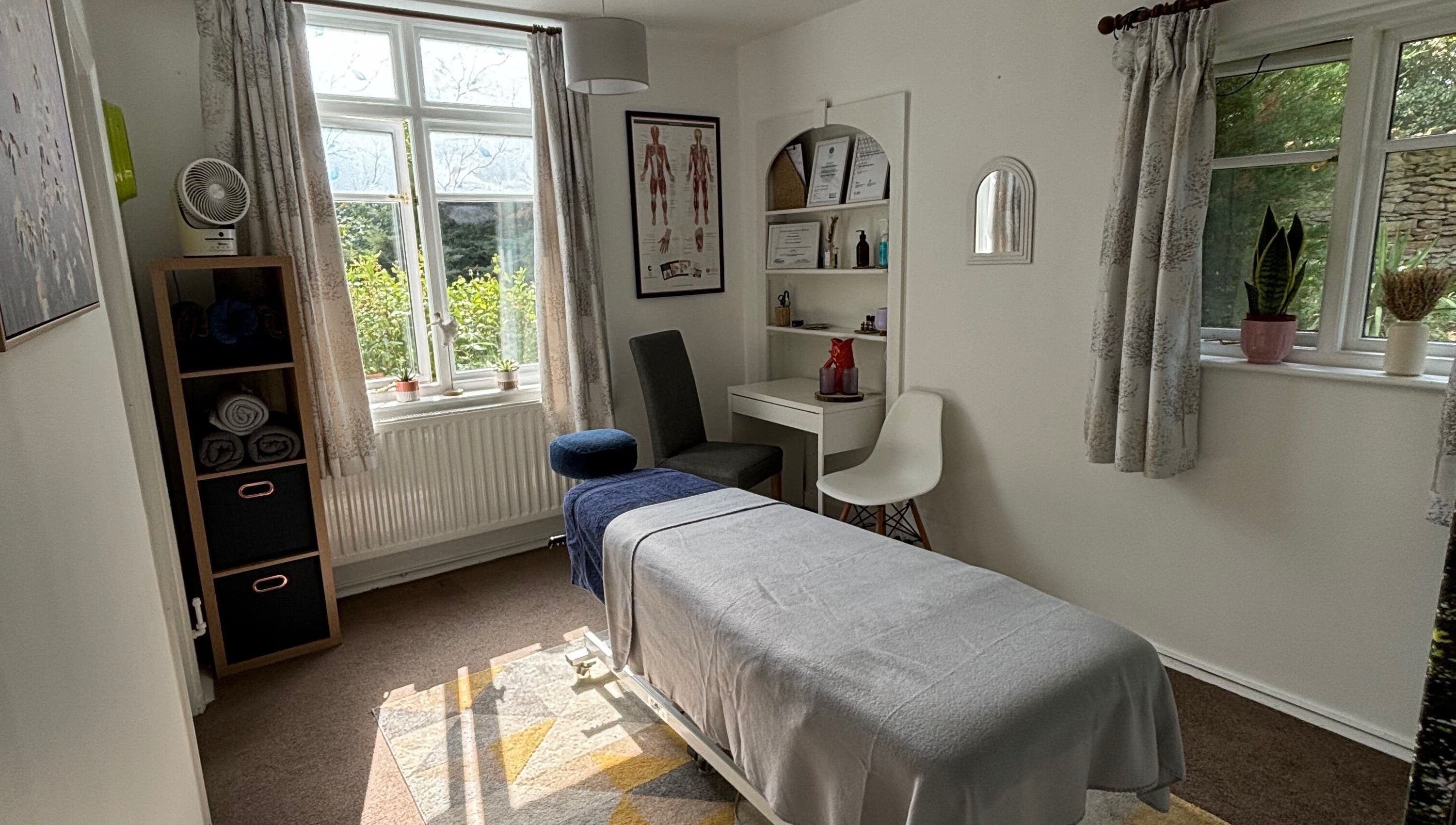 Calming therapy room at Rooted Wellness in Kineton, England, GB featuring a massage table and serene decor.