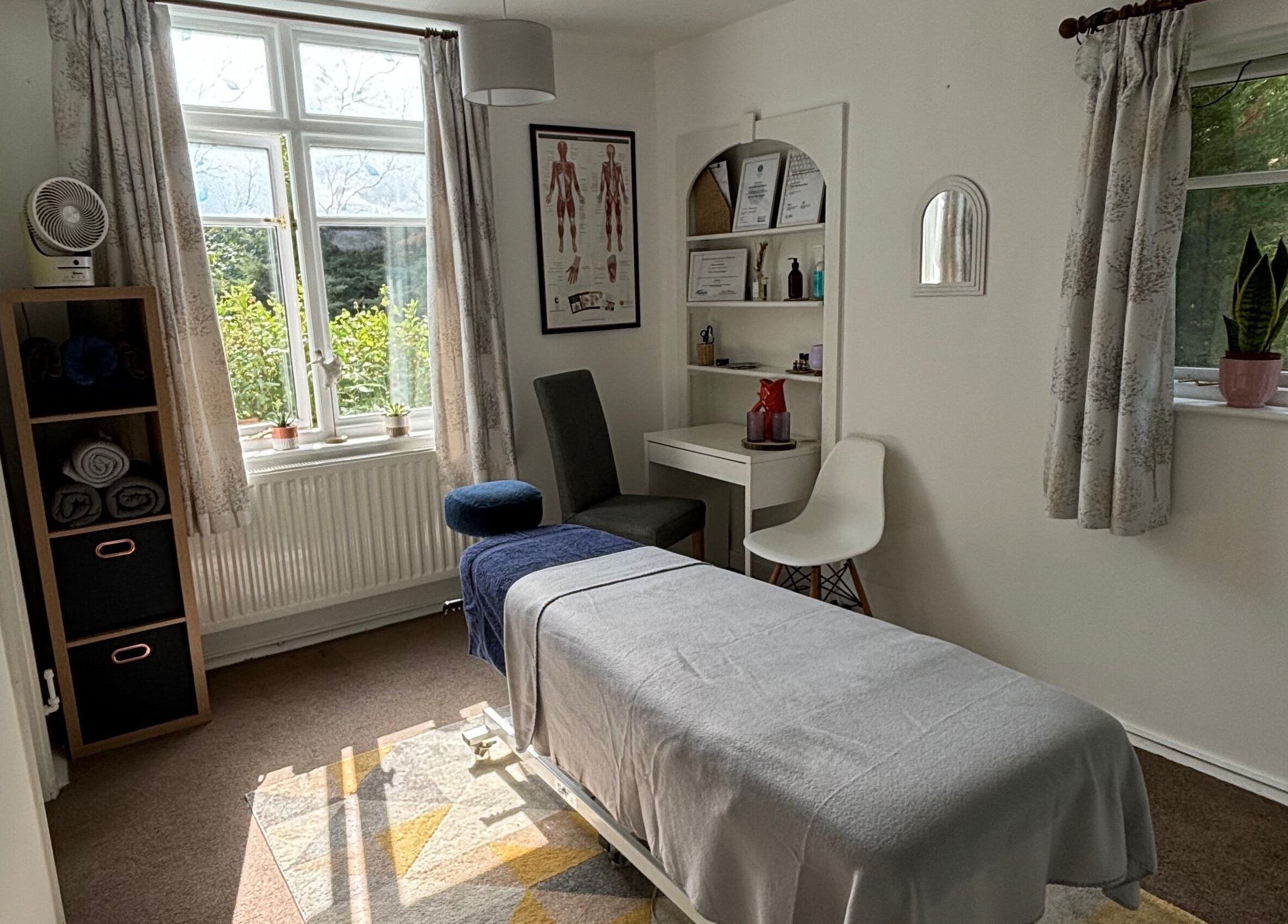 Calming therapy room at Rooted Wellness in Kineton, England, GB featuring a massage table and serene decor.
