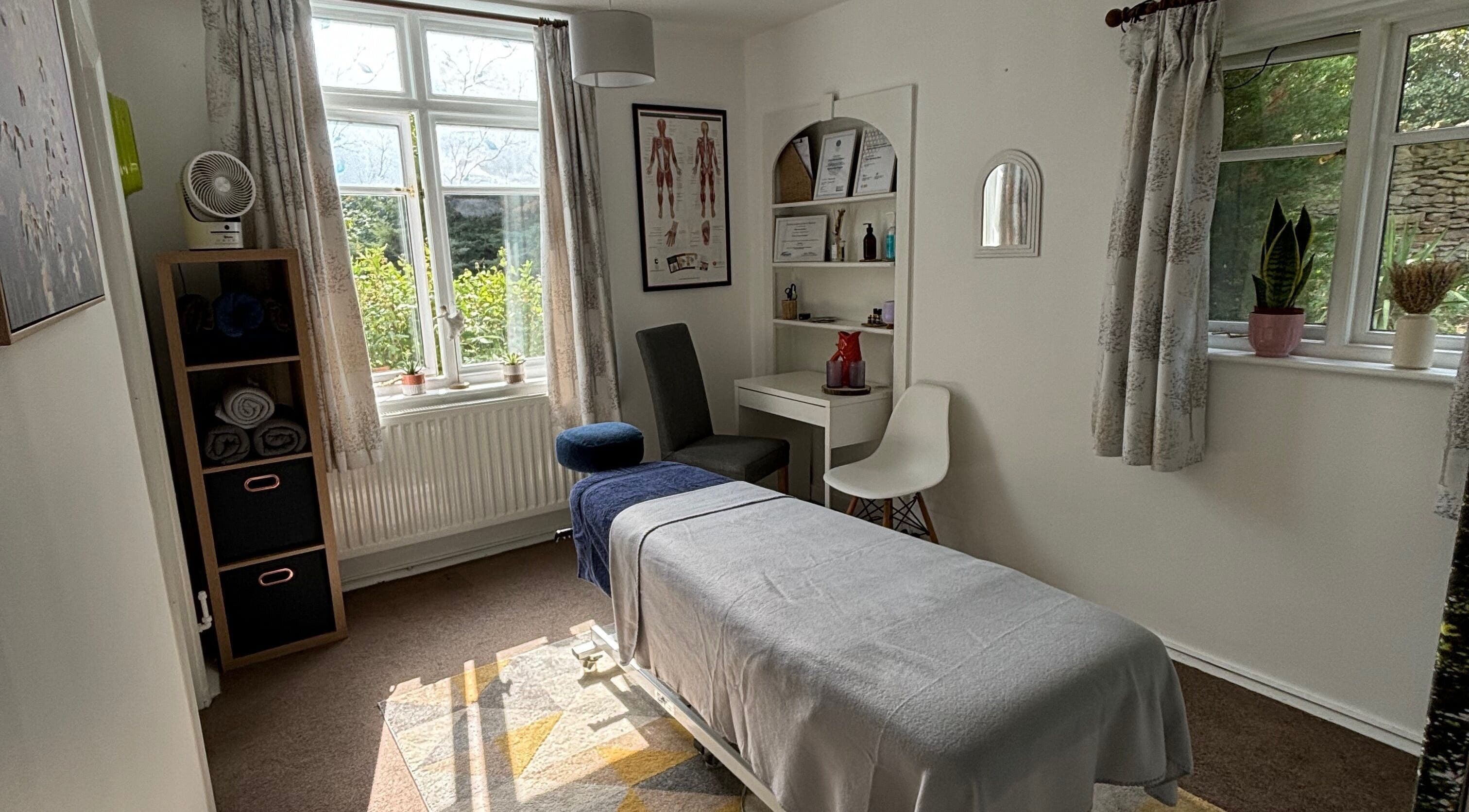 Calming therapy room at Rooted Wellness in Kineton, England, GB featuring a massage table and serene decor.
