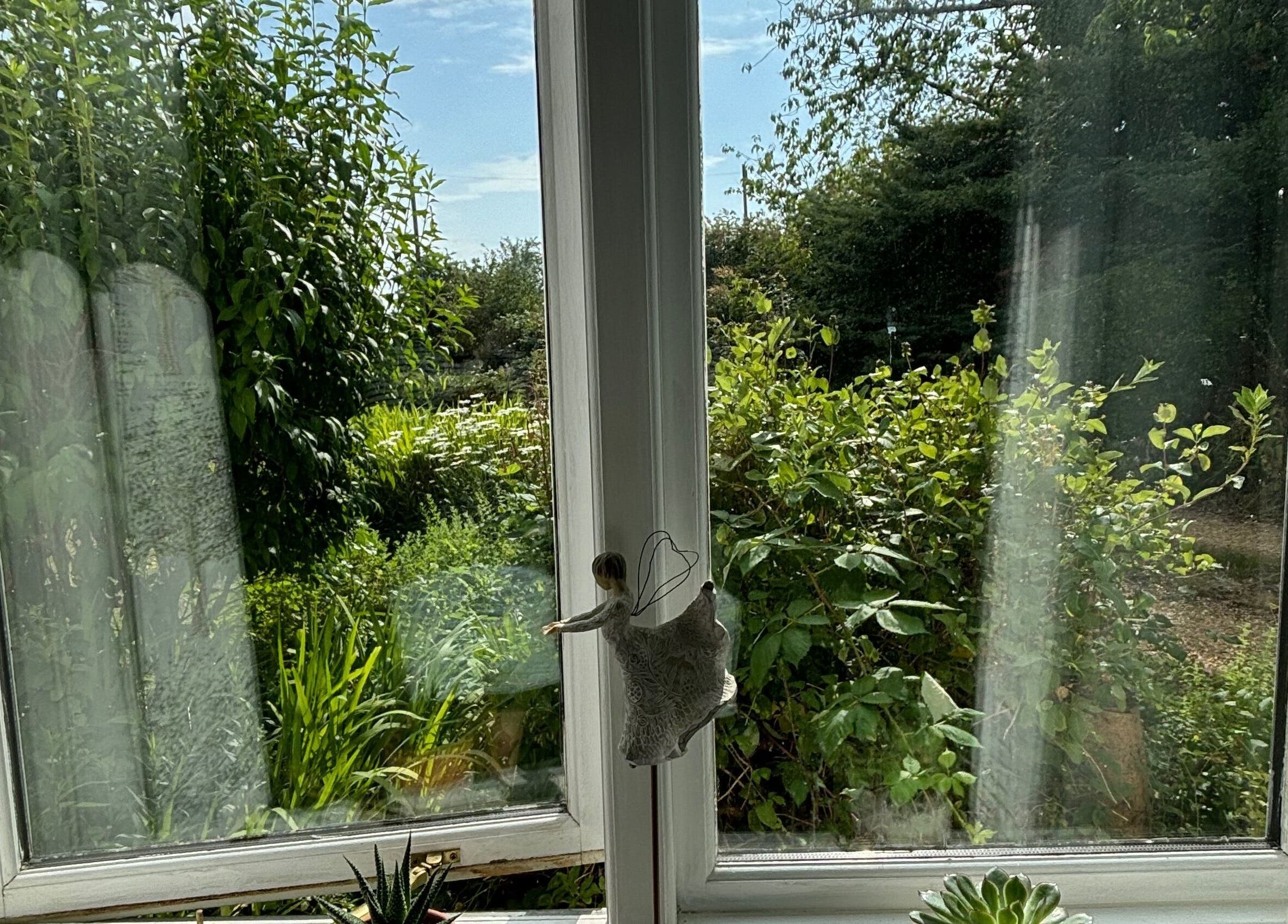 Lush garden view from Rooted Wellness window in Kineton, England, GB. Tranquil greenery and relaxed ambiance.