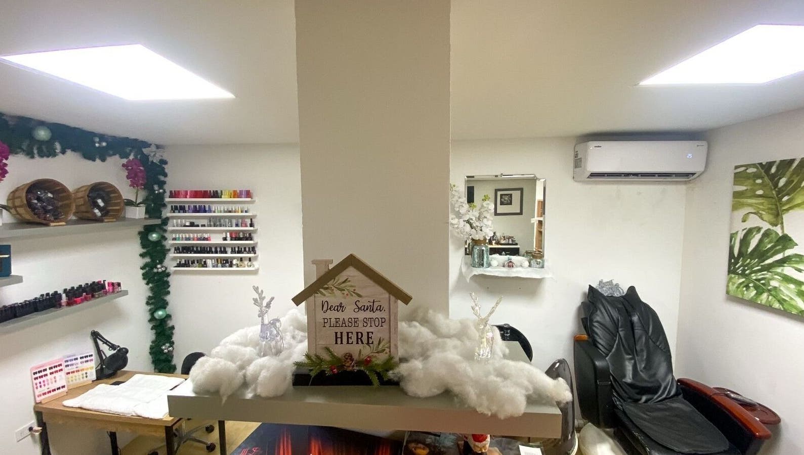 Cozy interior of Nelly's Touch Of Elegance Day Spa in Philipsburg, SX with festive decorations and manicure setup.