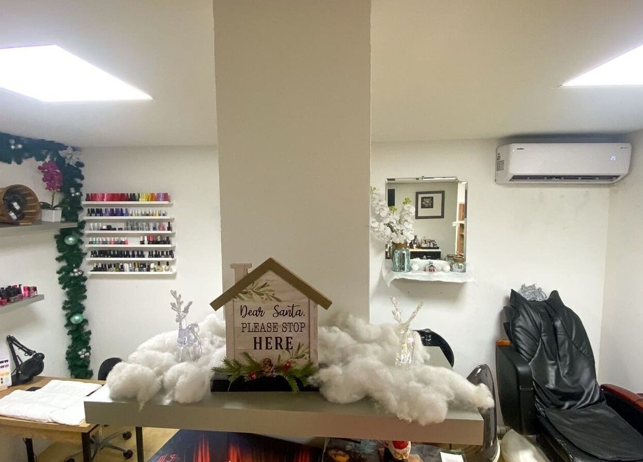 Cozy interior of Nelly's Touch Of Elegance Day Spa in Philipsburg, SX with festive decorations and manicure setup.