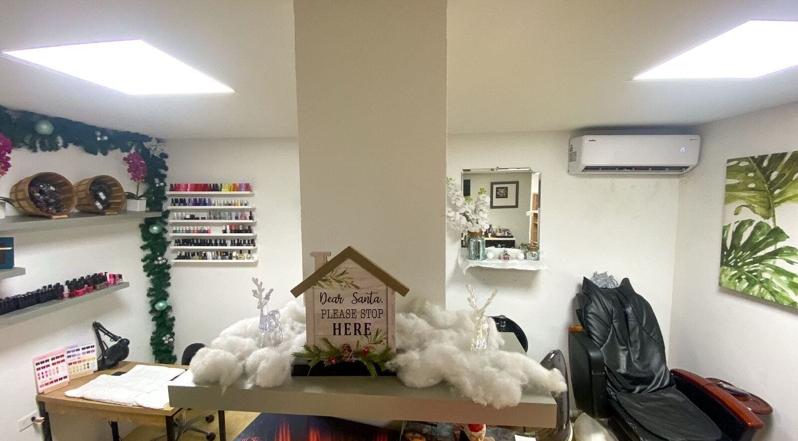 Cozy interior of Nelly's Touch Of Elegance Day Spa in Philipsburg, SX with festive decorations and manicure setup.