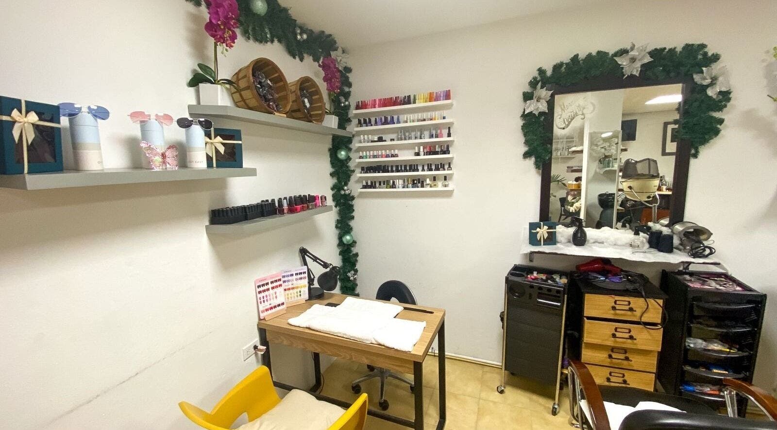 Cozy nail treatment area at Nelly's Touch Of Elegance Day Spa, Philipsburg, SX with vibrant polish display.