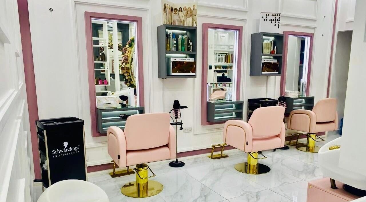 Luxurious styling area at Hair Masters Ladies Salon LLC in Dubai, Dubai, AE with pink chairs and mirrors.