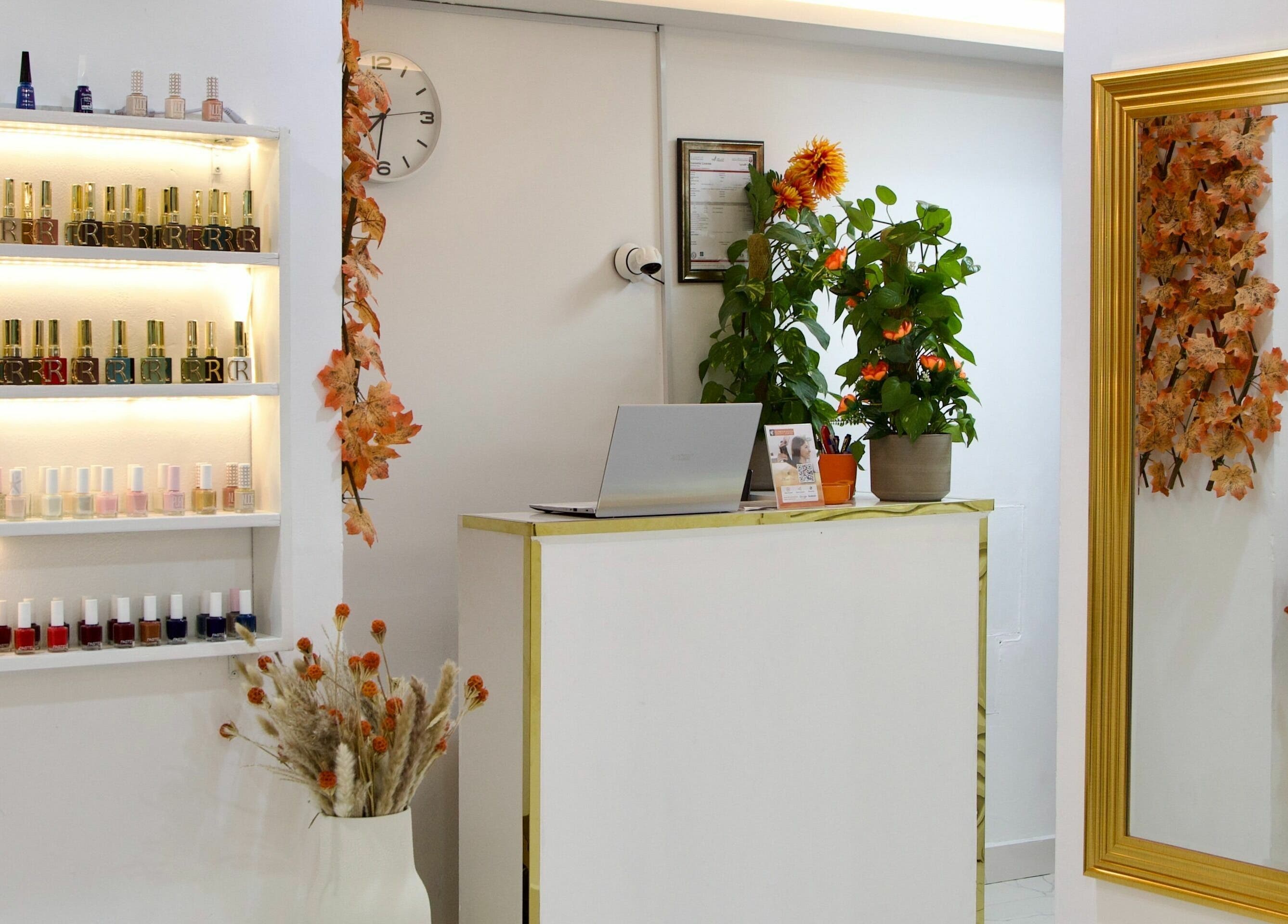 Reception area at Glamour Haven Beauty Center, Abu Dhabi. Features nail polish display and elegant decor.