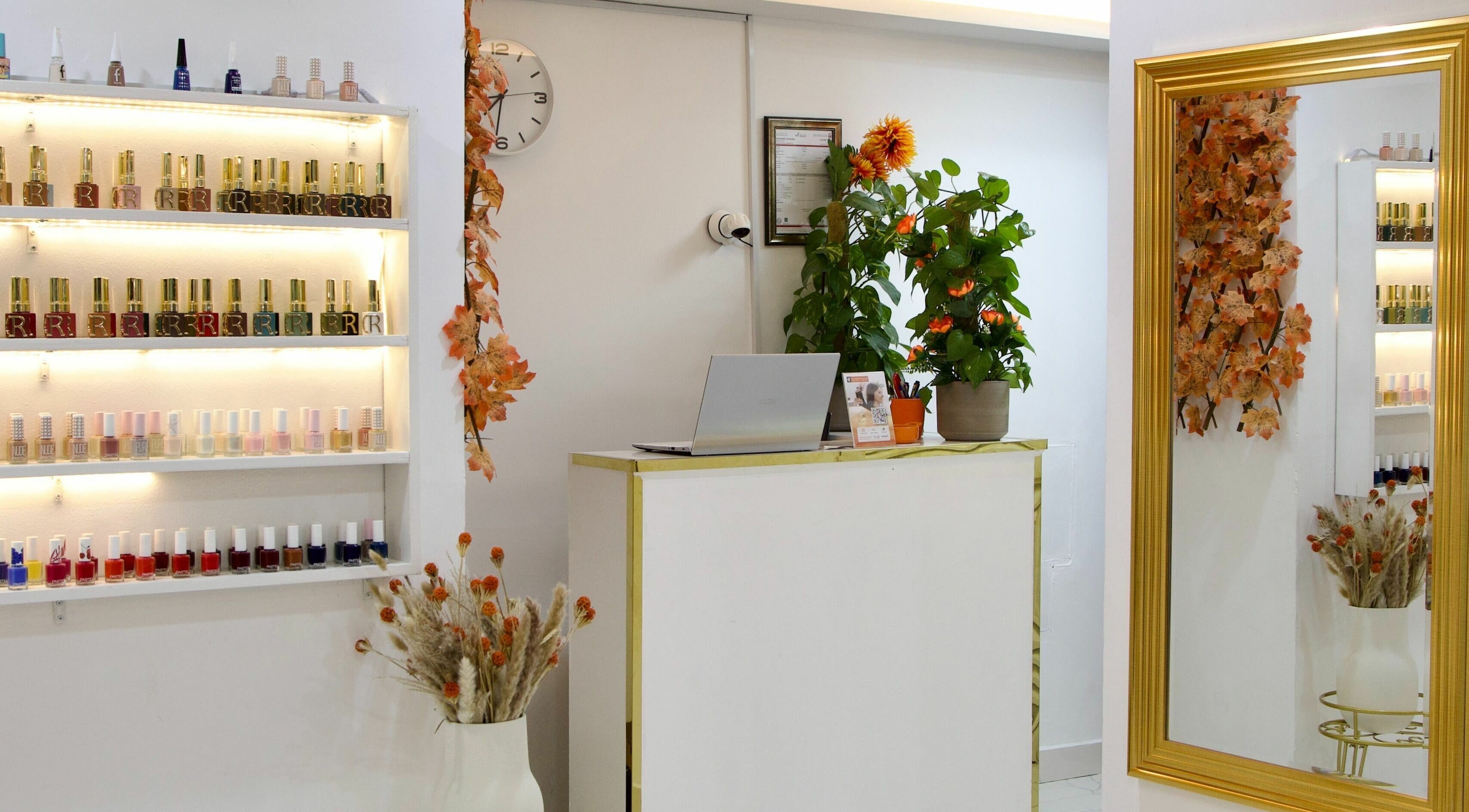 Reception area at Glamour Haven Beauty Center, Abu Dhabi. Features nail polish display and elegant decor.