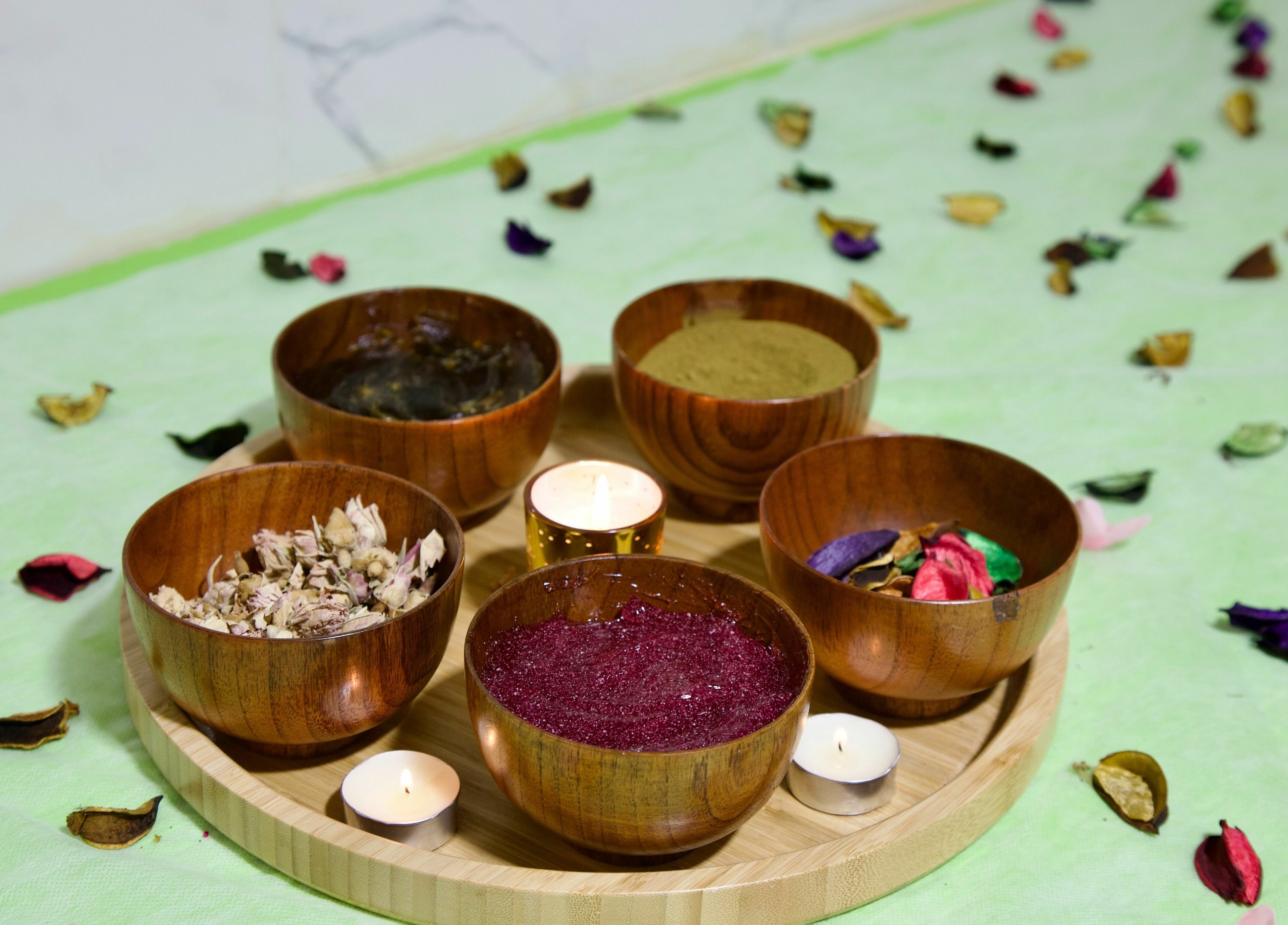 Herbal treatment bowls at Glamour Haven Beauty Center, Abu Dhabi, Abu Dhabi, AE with candles and petals.