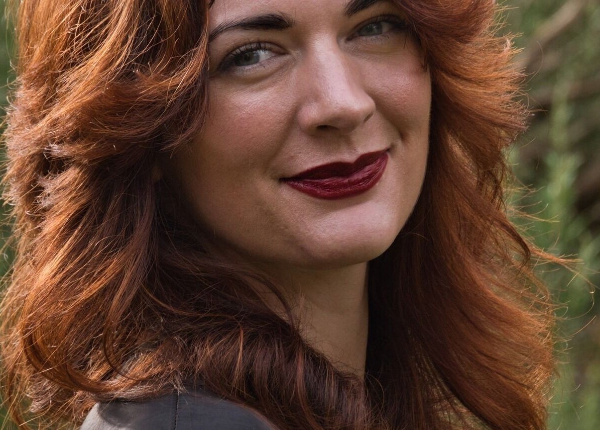 Woman with red hair smiling at Alice Capriotti in Lavenham, England, GB.