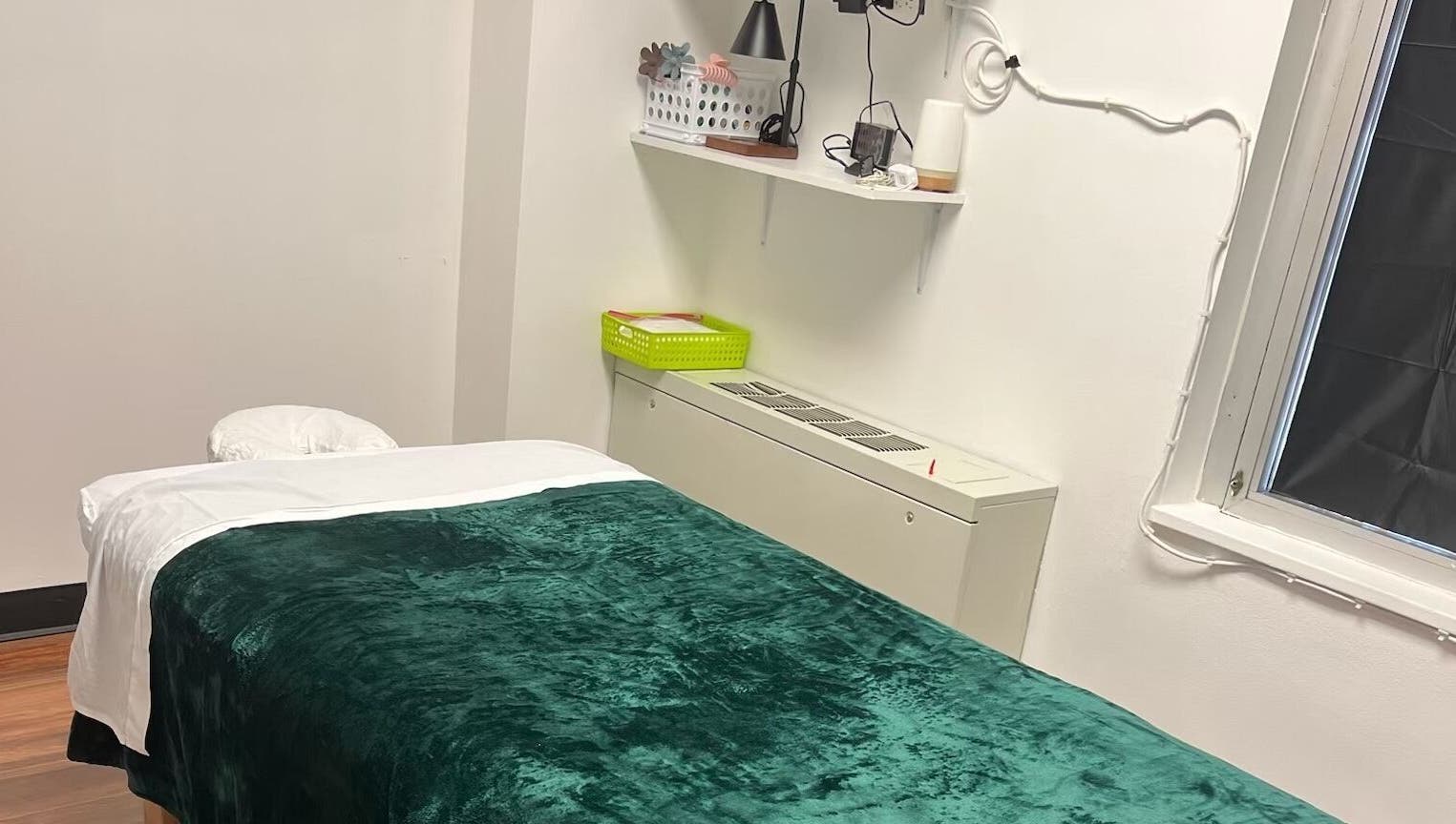 Serene massage room at Sunee Massage Bodywork and Spa LLC, Falls Church, Virginia, US, featuring a plush green blanket.