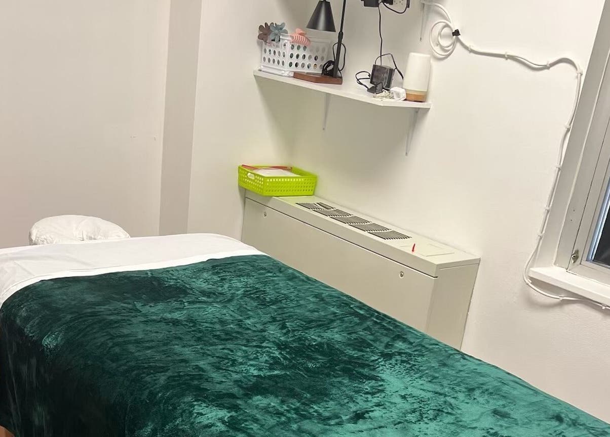 Serene massage room at Sunee Massage Bodywork and Spa LLC, Falls Church, Virginia, US, featuring a plush green blanket.