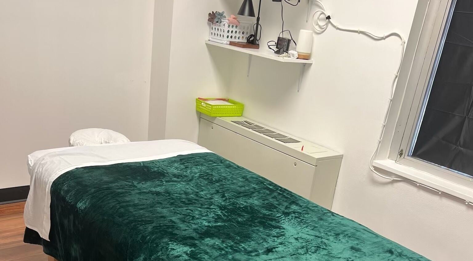 Serene massage room at Sunee Massage Bodywork and Spa LLC, Falls Church, Virginia, US, featuring a plush green blanket.