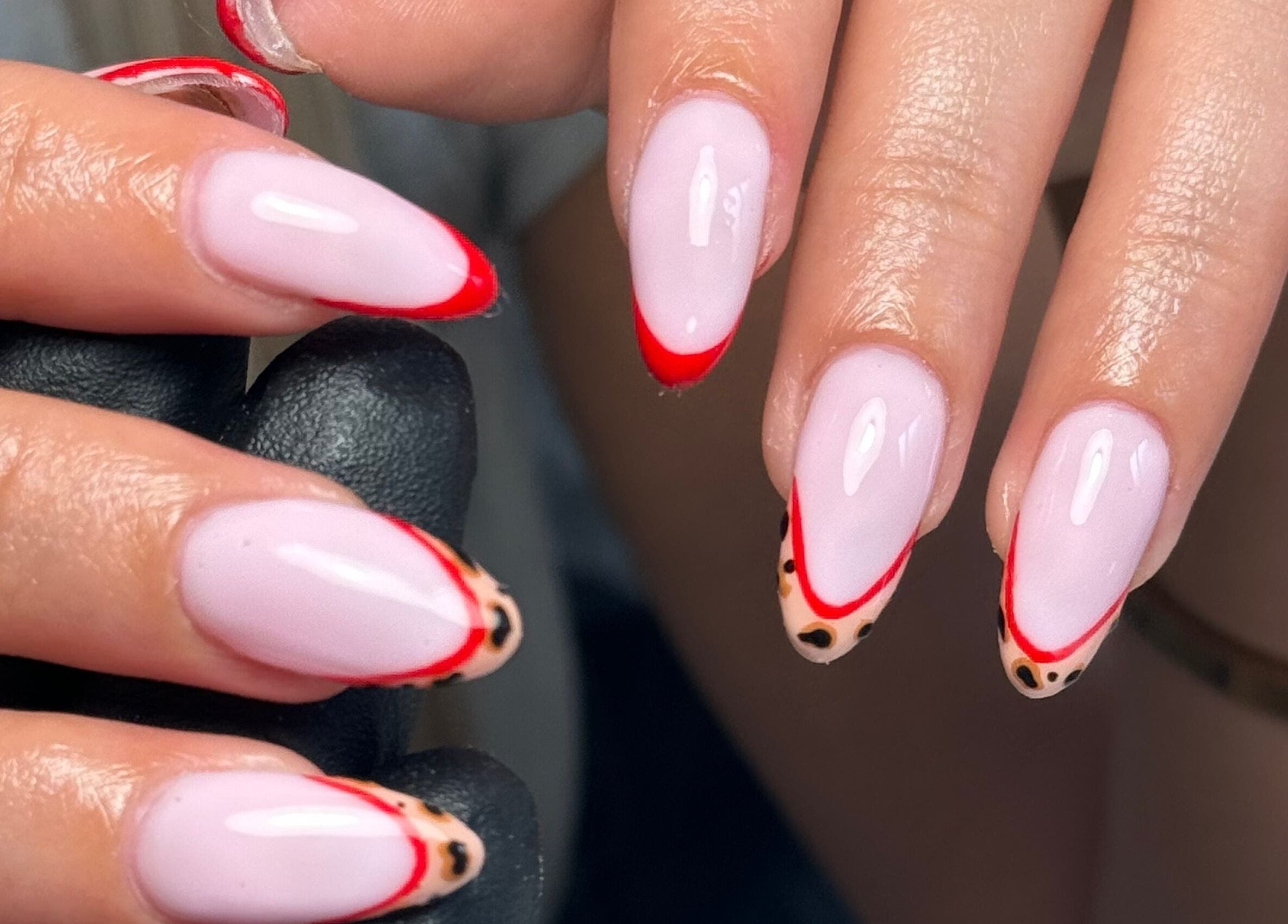 Stylish nail design with red and leopard tips at Biabbarr, Cardiff, Wales, GB.