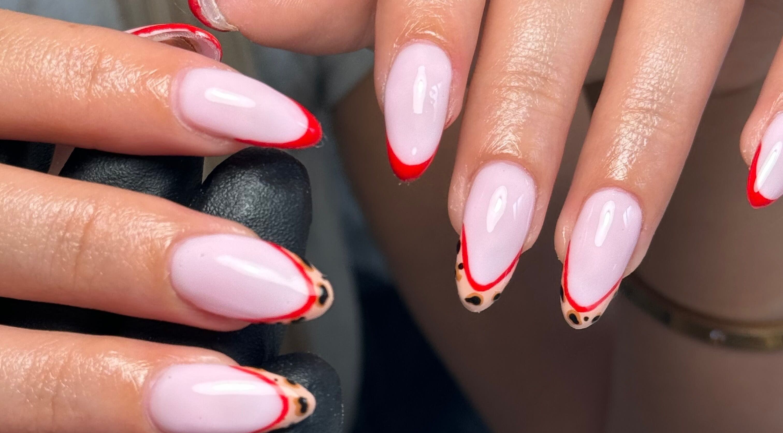 Stylish nail design with red and leopard tips at Biabbarr, Cardiff, Wales, GB.