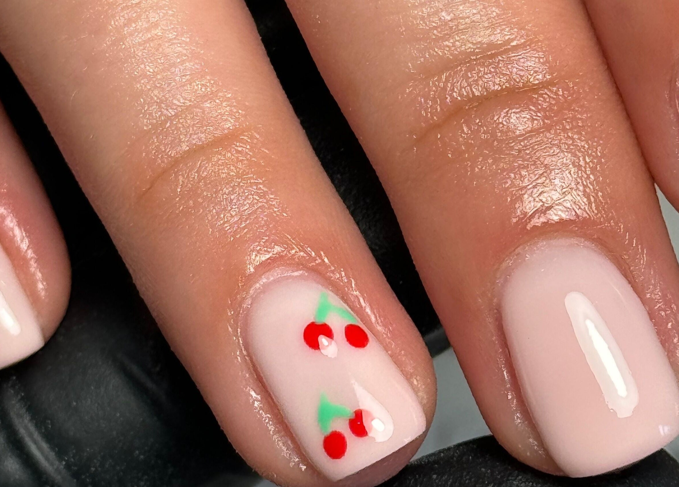 Cherry nail art at Biabbarr, Cardiff, Wales, GB showcasing elegant design and detailed craftsmanship.