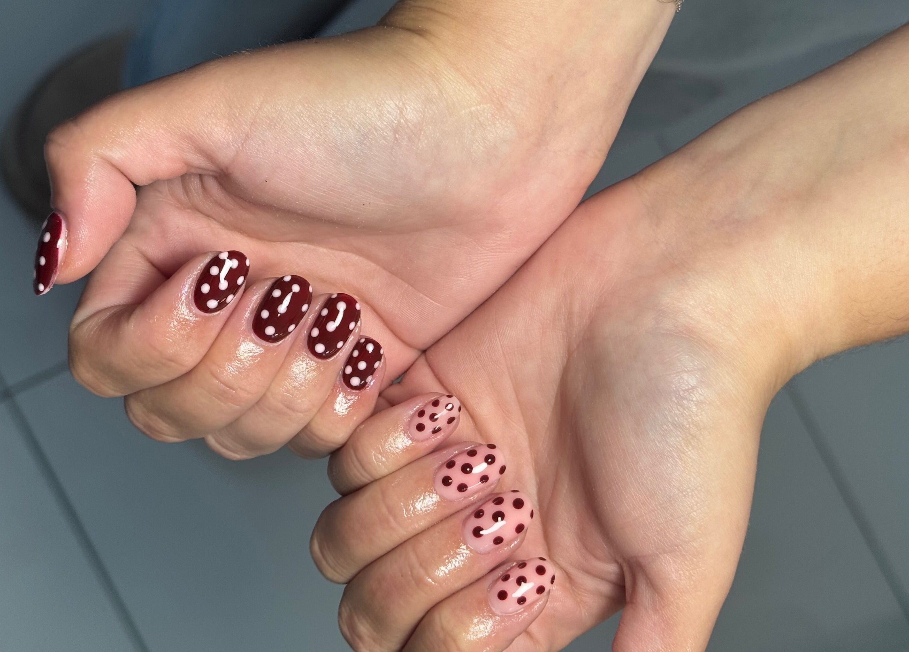 Polka dot nail art in red and pink at Biabbarr, Cardiff, Wales, GB.