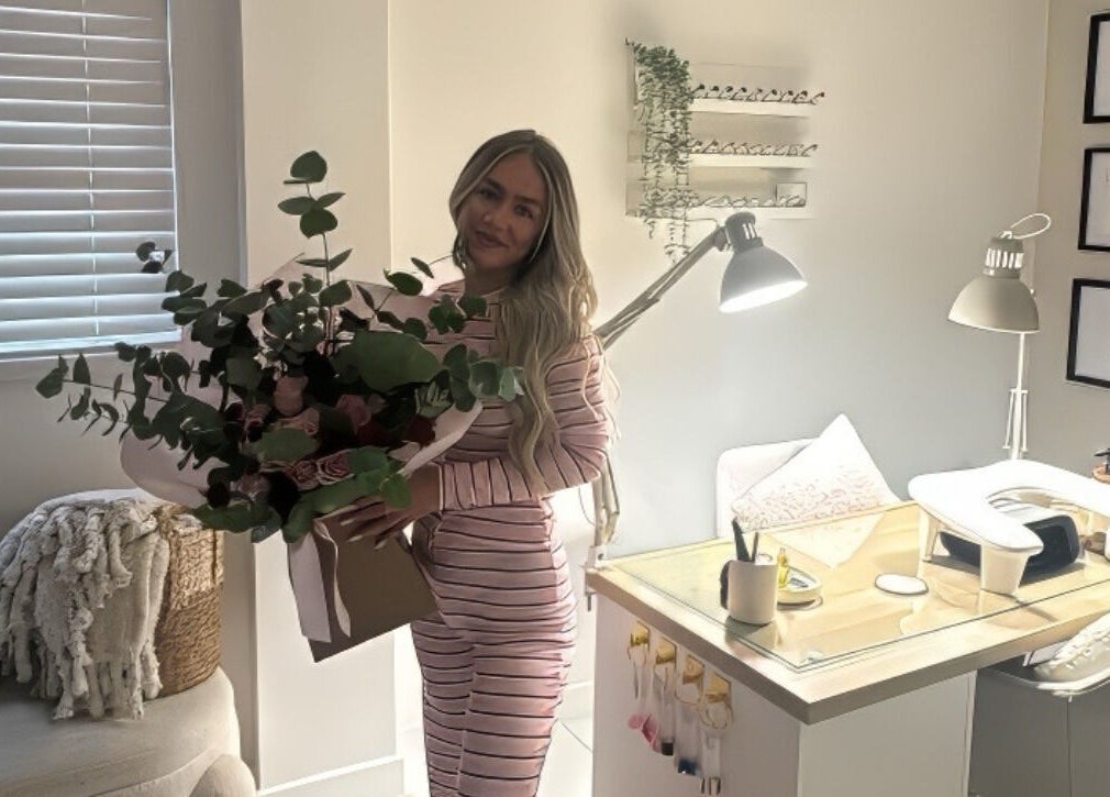 Cozy beauty corner at Biabbarr, Cardiff, Wales, GB with a woman holding a flower bouquet.