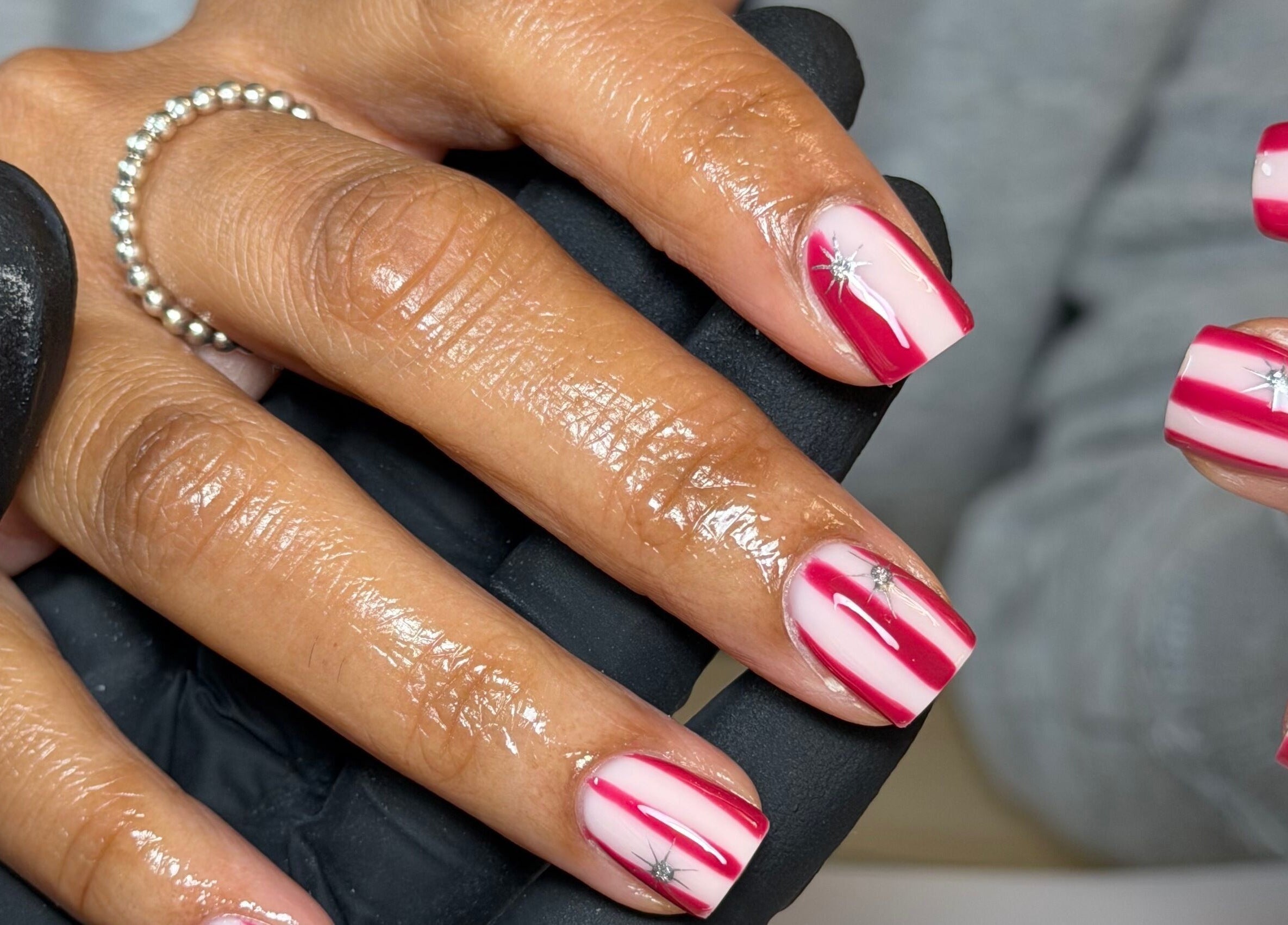 Stylish red and white nail art at Biabbarr in Cardiff, Wales, GB, showcasing elegant design.