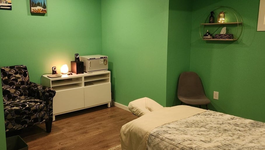 Relaxing massage room at Massageopedia, Edmonton, Alberta, CA with soft lighting and comfortable seating.