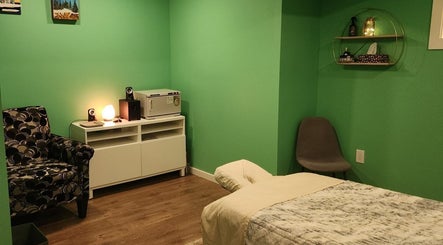 Relaxing massage room at Massageopedia, Edmonton, Alberta, CA with soft lighting and comfortable seating.