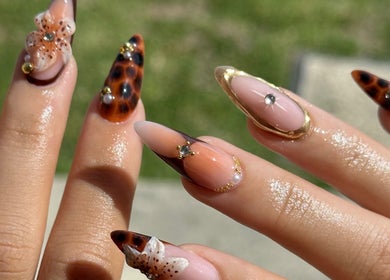 Intricate nail art at The Suga House Nail Artistry in Melbourne, Victoria, AU showcasing gold and floral designs.