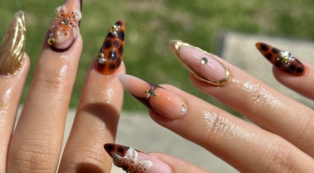 Intricate nail art at The Suga House Nail Artistry in Melbourne, Victoria, AU showcasing gold and floral designs.