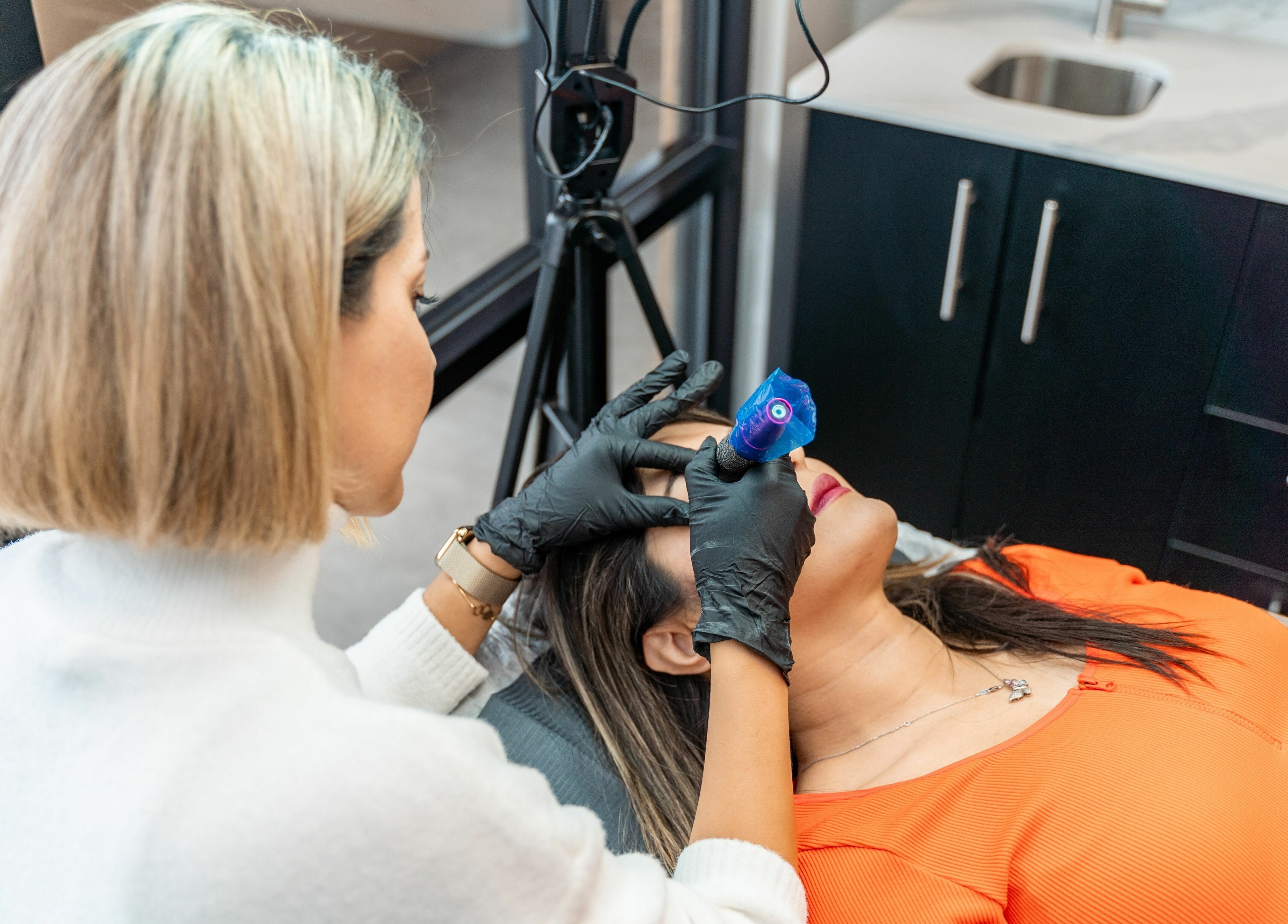 Skilled esthetician performs microblading at Phi Beauty Spa - Total Salons Unit #126, Neptune Beach, Florida, US.