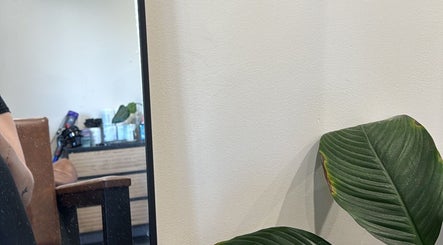 Relaxing salon corner at Hair by Jaz, Catalina, New South Wales, AU with plants and cozy seating.