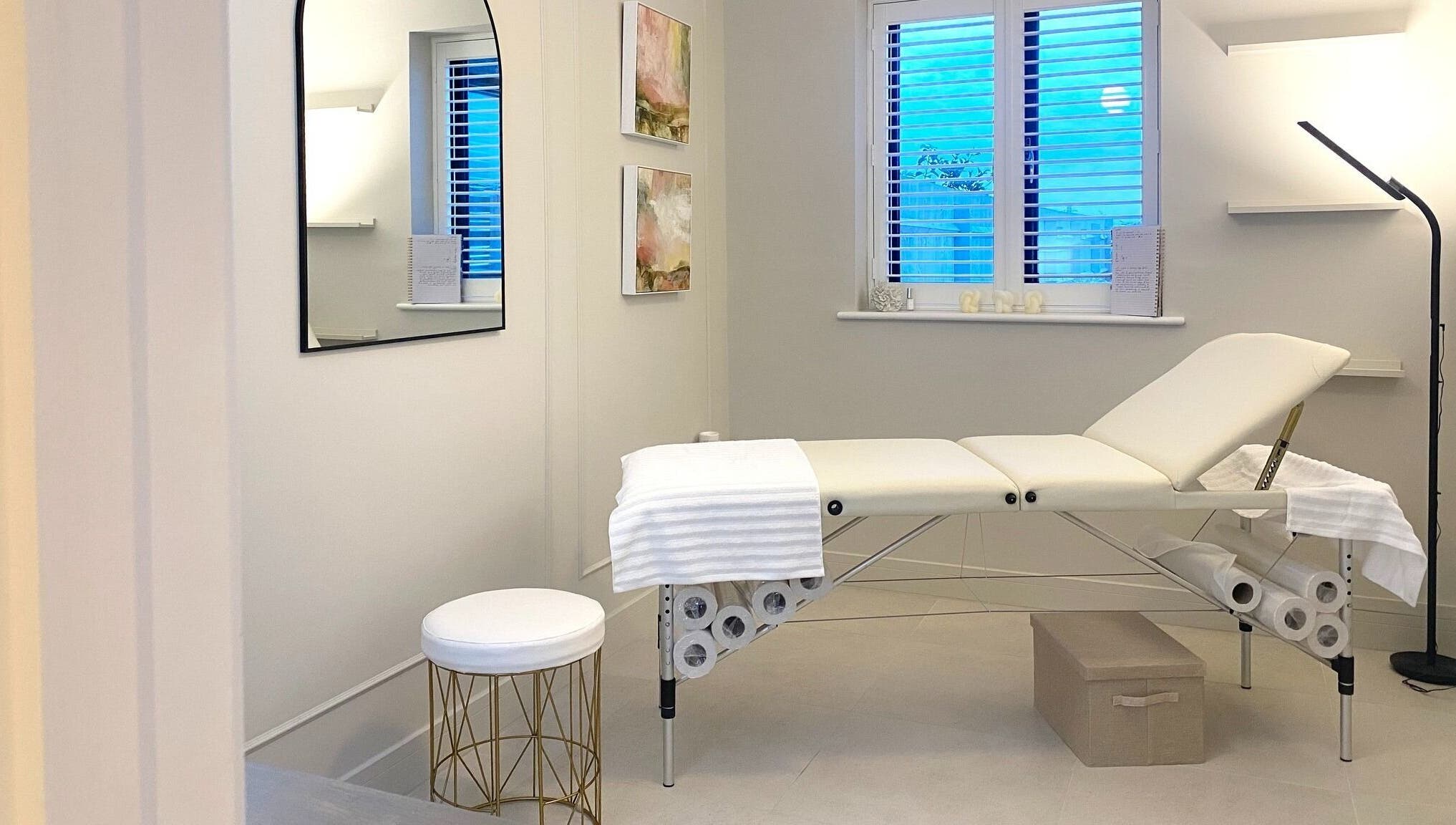 Calm treatment room at R Skin Aesthetics, Evesham, England, GB, with a cushioned bed and subtle decor.
