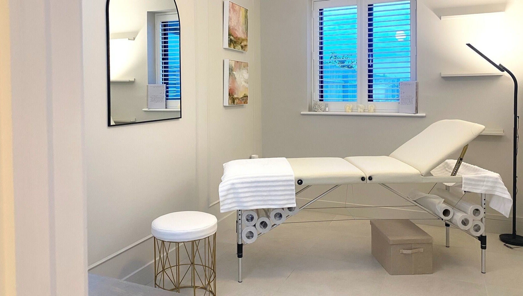 Calm treatment room at R Skin Aesthetics, Evesham, England, GB, with a cushioned bed and subtle decor.
