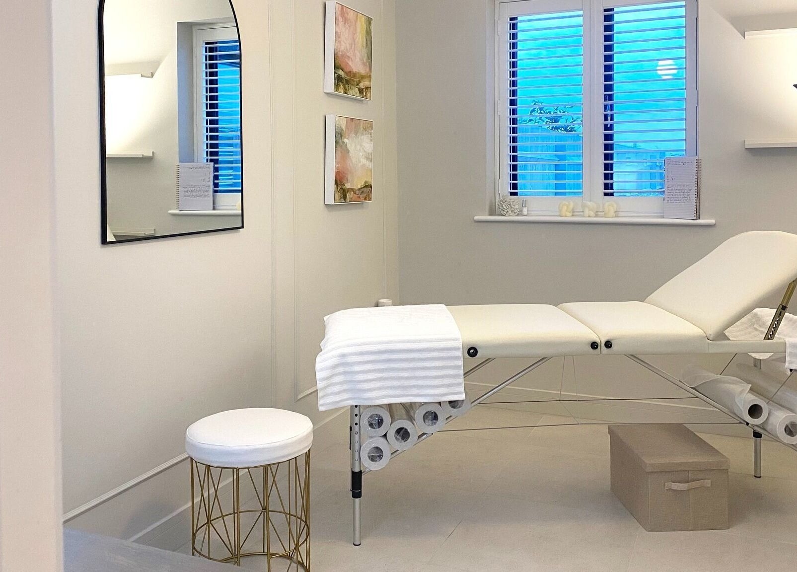 Calm treatment room at R Skin Aesthetics, Evesham, England, GB, with a cushioned bed and subtle decor.