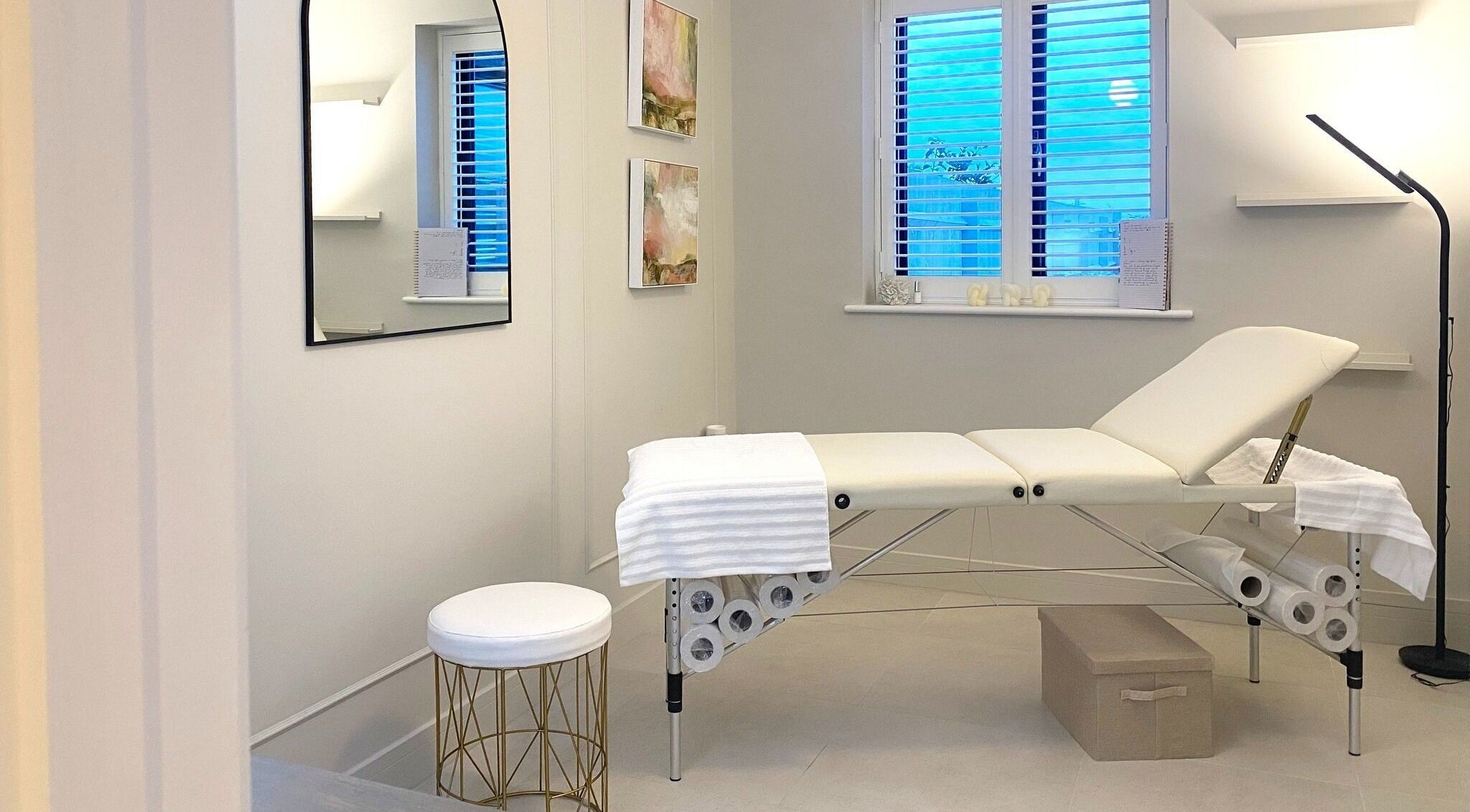 Calm treatment room at R Skin Aesthetics, Evesham, England, GB, with a cushioned bed and subtle decor.