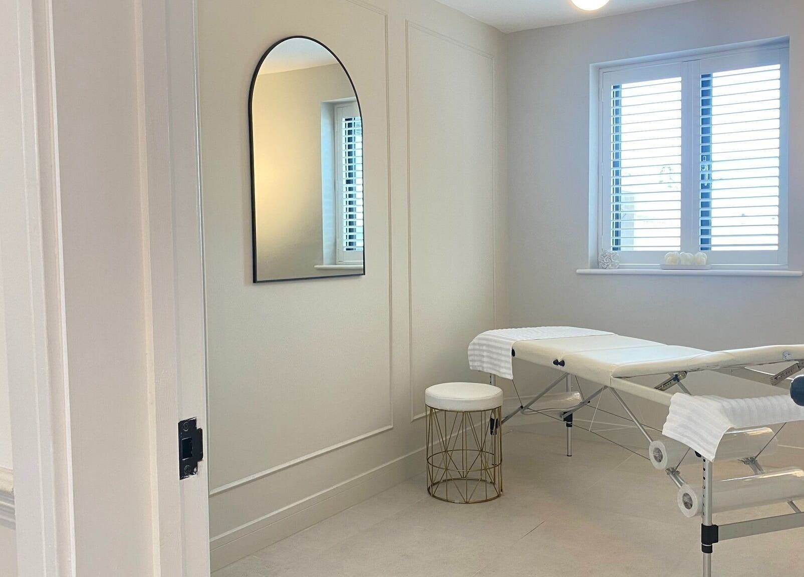 Tranquil treatment room at R Skin Aesthetics, Evesham, England, GB, showcasing a massage table under natural light.