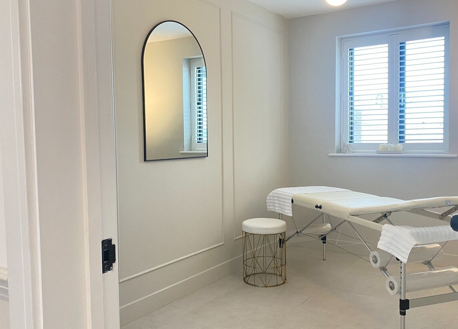 Tranquil treatment room at R Skin Aesthetics, Evesham, England, GB, showcasing a massage table under natural light.
