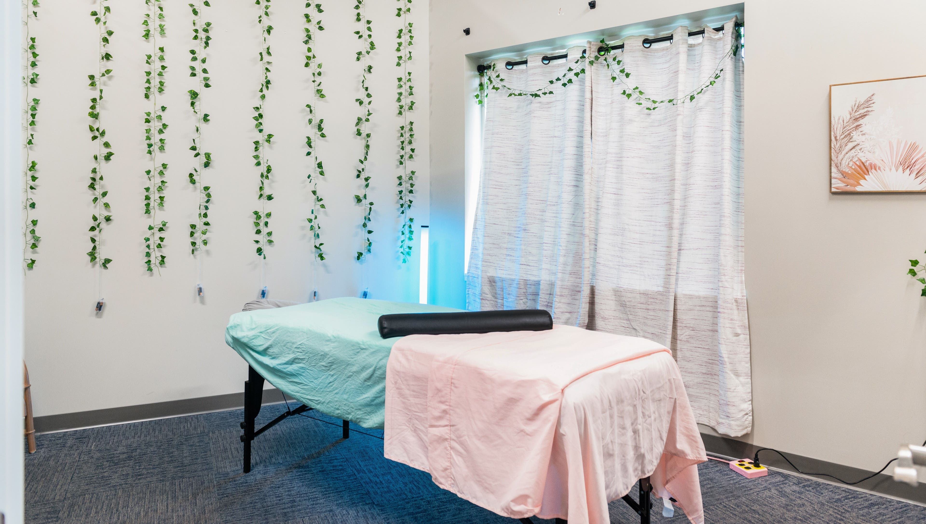 Cozy massage room at Tropical Touch Spa in Jenison, Michigan, US with calming decor.