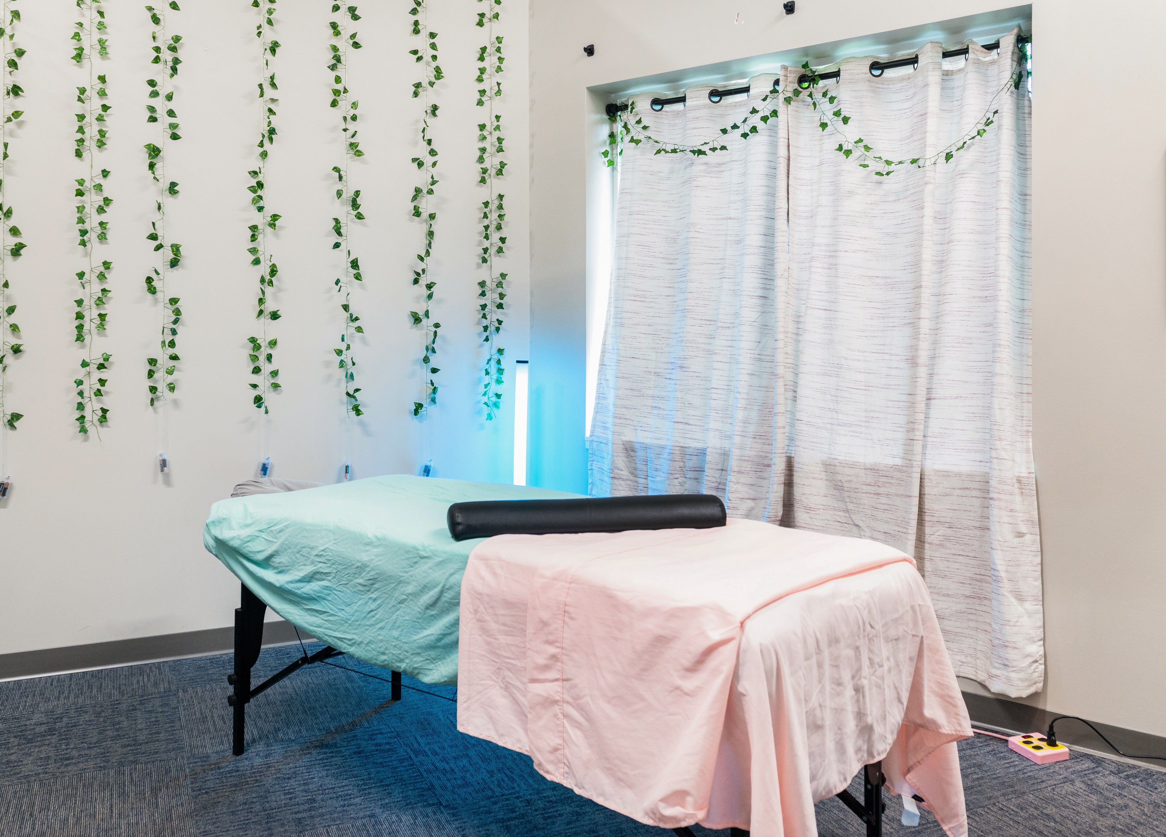 Cozy massage room at Tropical Touch Spa in Jenison, Michigan, US with calming decor.