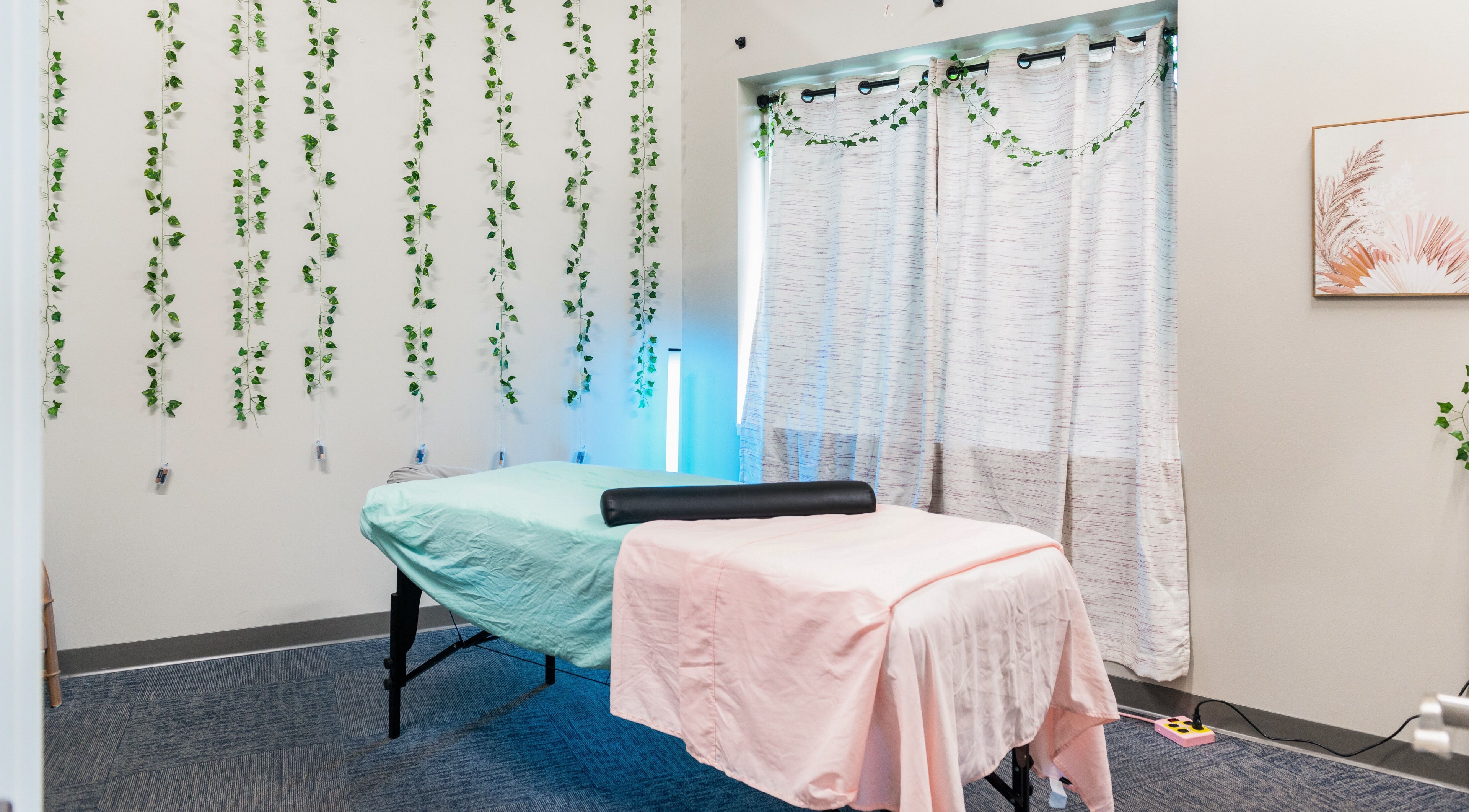 Cozy massage room at Tropical Touch Spa in Jenison, Michigan, US with calming decor.