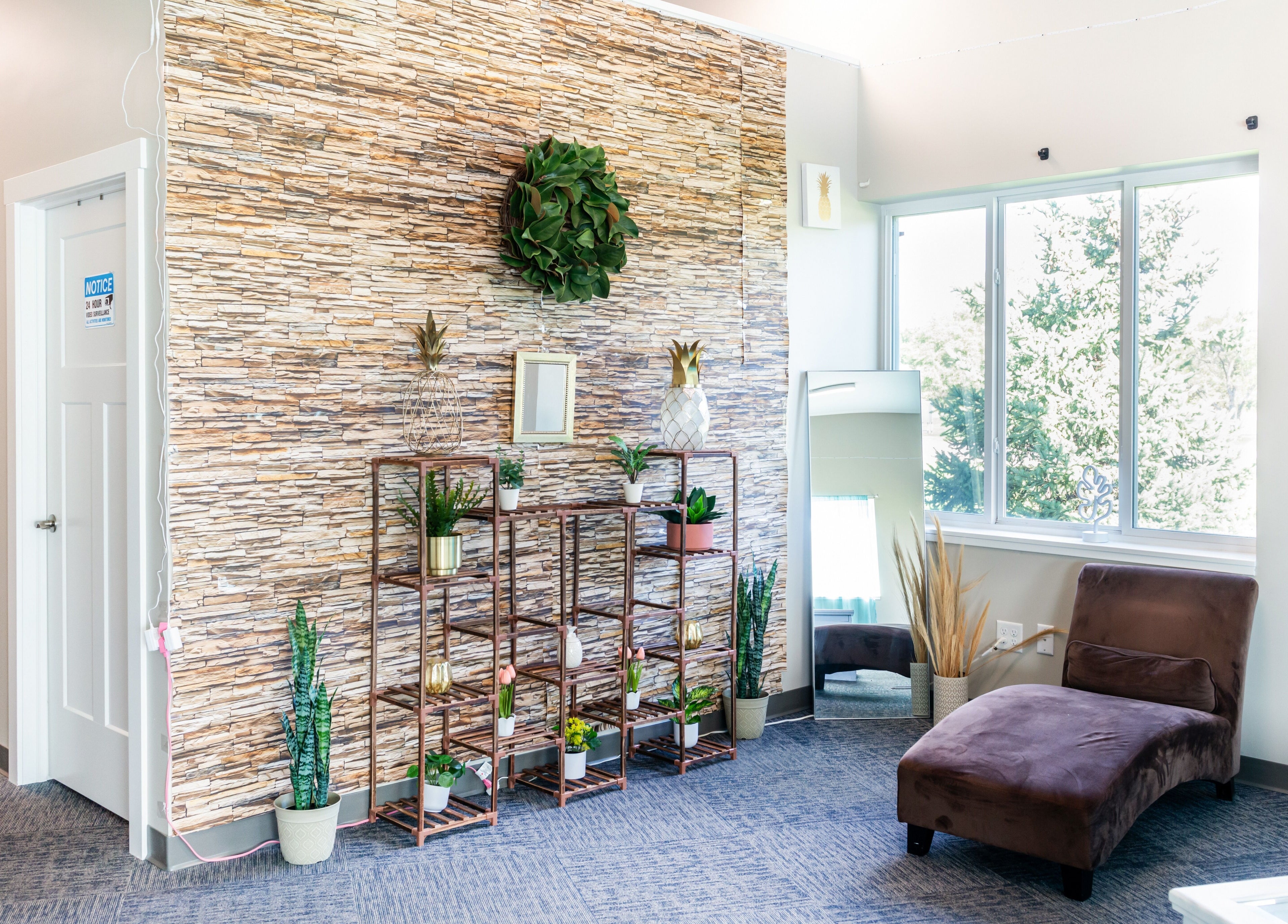 Bright, serene waiting area at Tropical Touch Spa, Jenison, Michigan, US with plants and comfy seating.