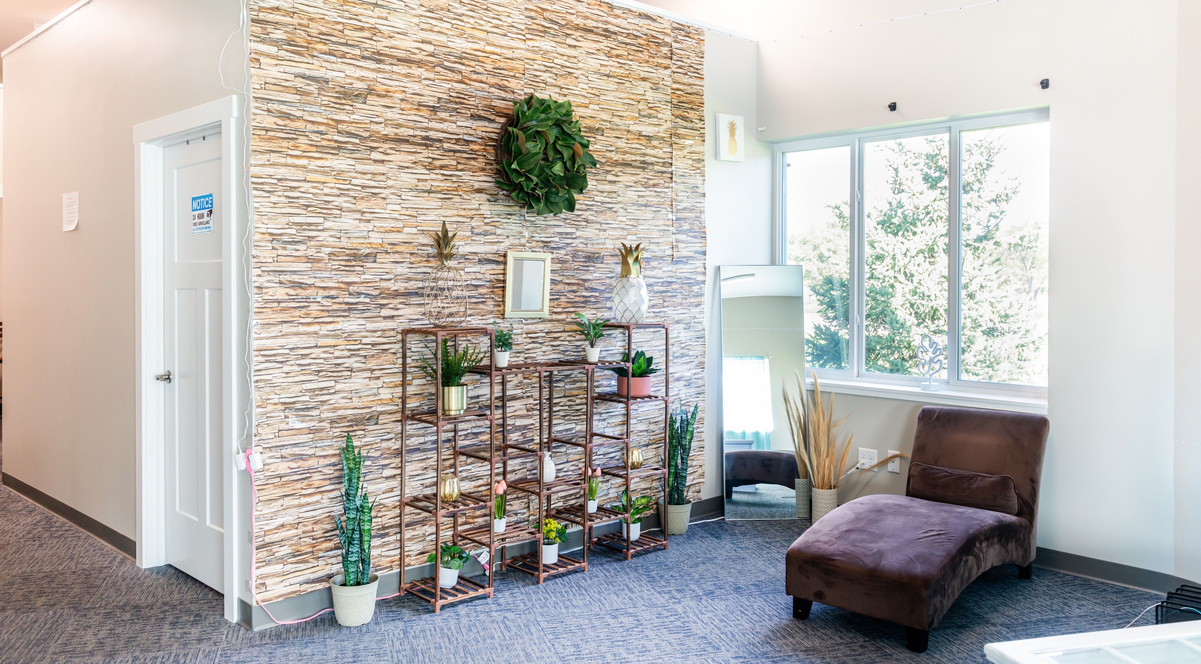 Bright, serene waiting area at Tropical Touch Spa, Jenison, Michigan, US with plants and comfy seating.