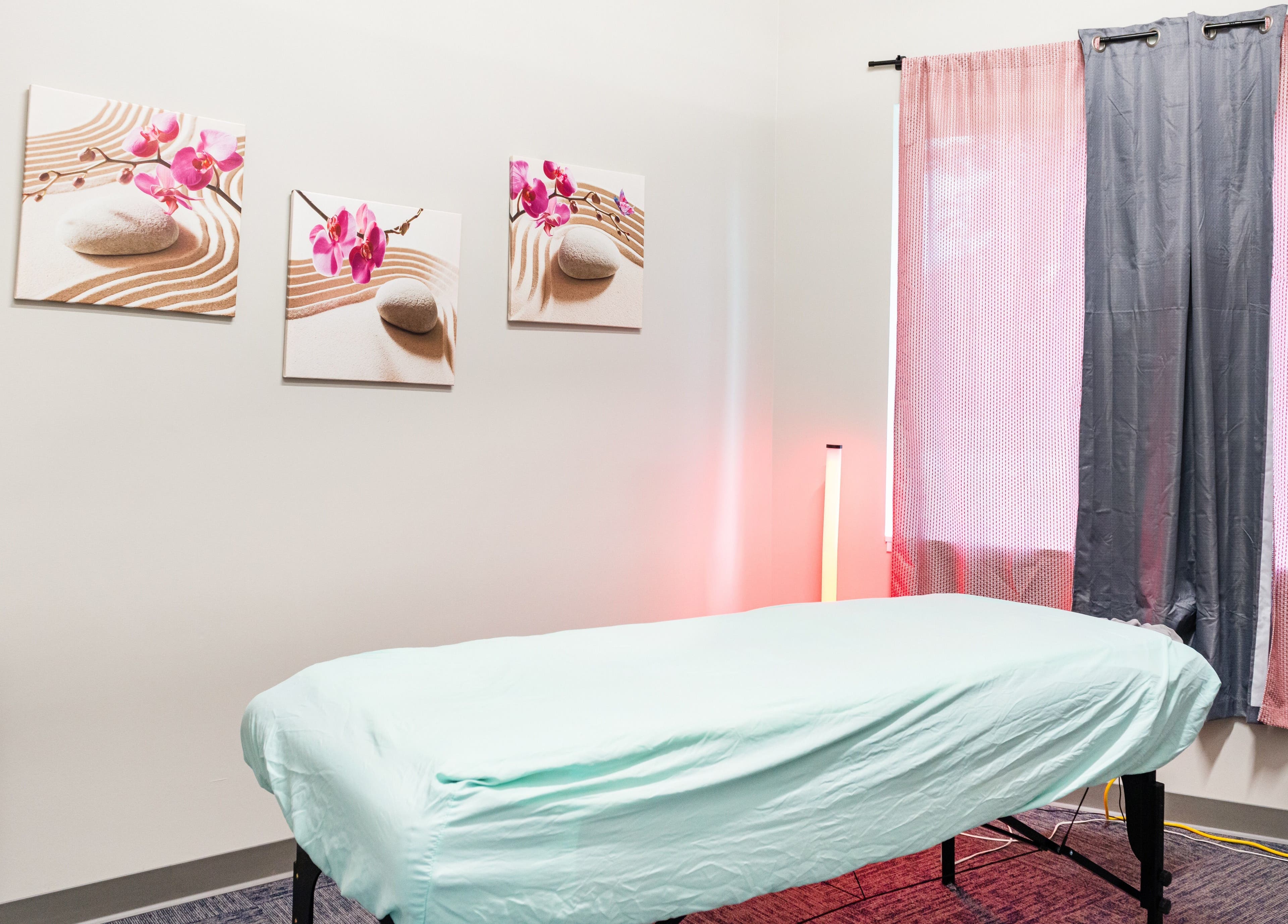 Massage room at Tropical Touch Spa in Jenison, Michigan, US with calming decor and a massage table.