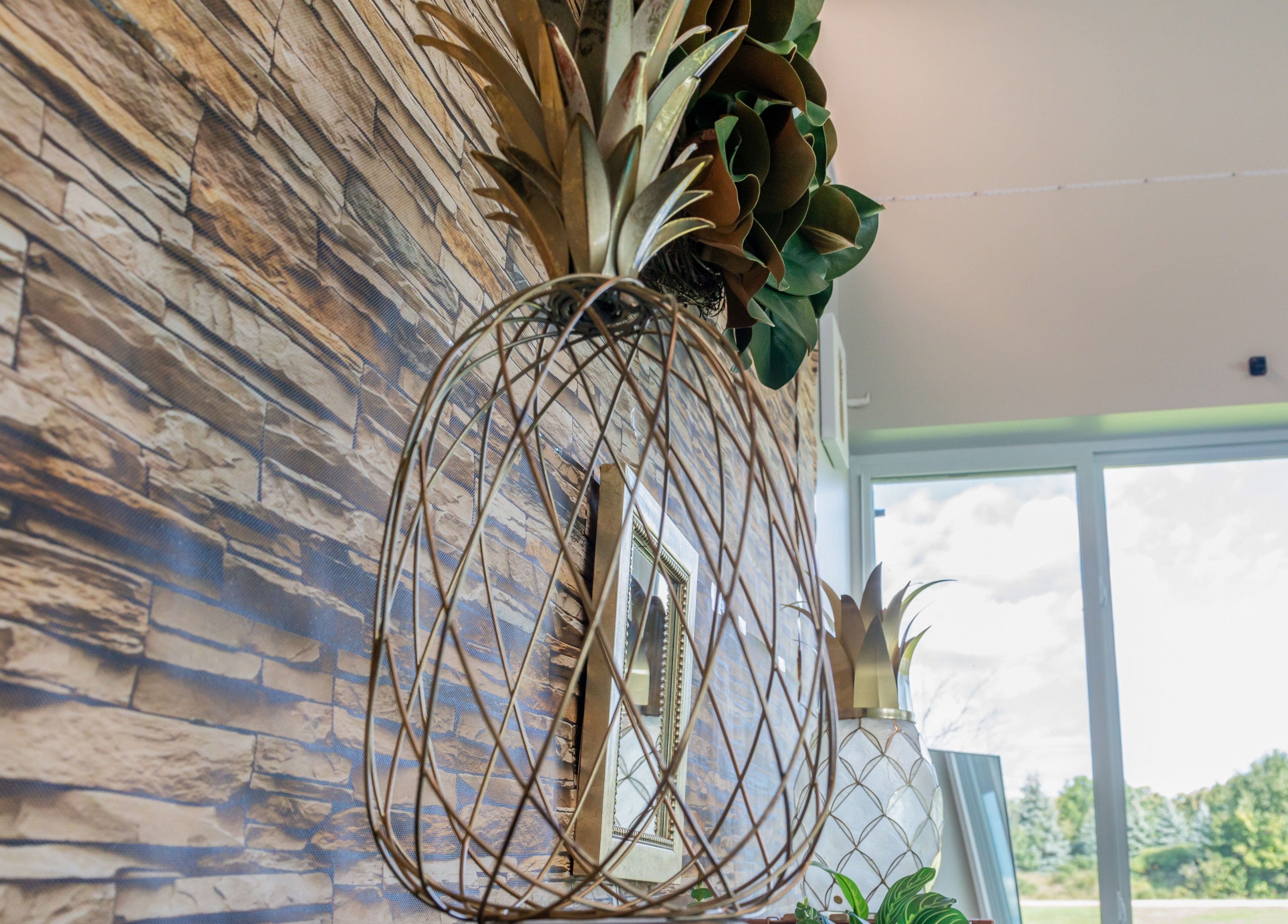 Elegant pineapple decor and greenery at Tropical Touch Spa, Jenison, Michigan, US, enhancing relaxation.