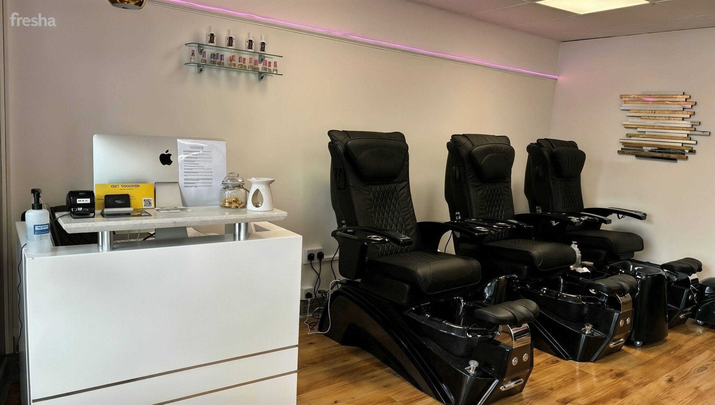 Stylish seating area at Bossy Nails and Beauty Spa in Ennis, County Clare, IE showcasing black pedicure chairs.