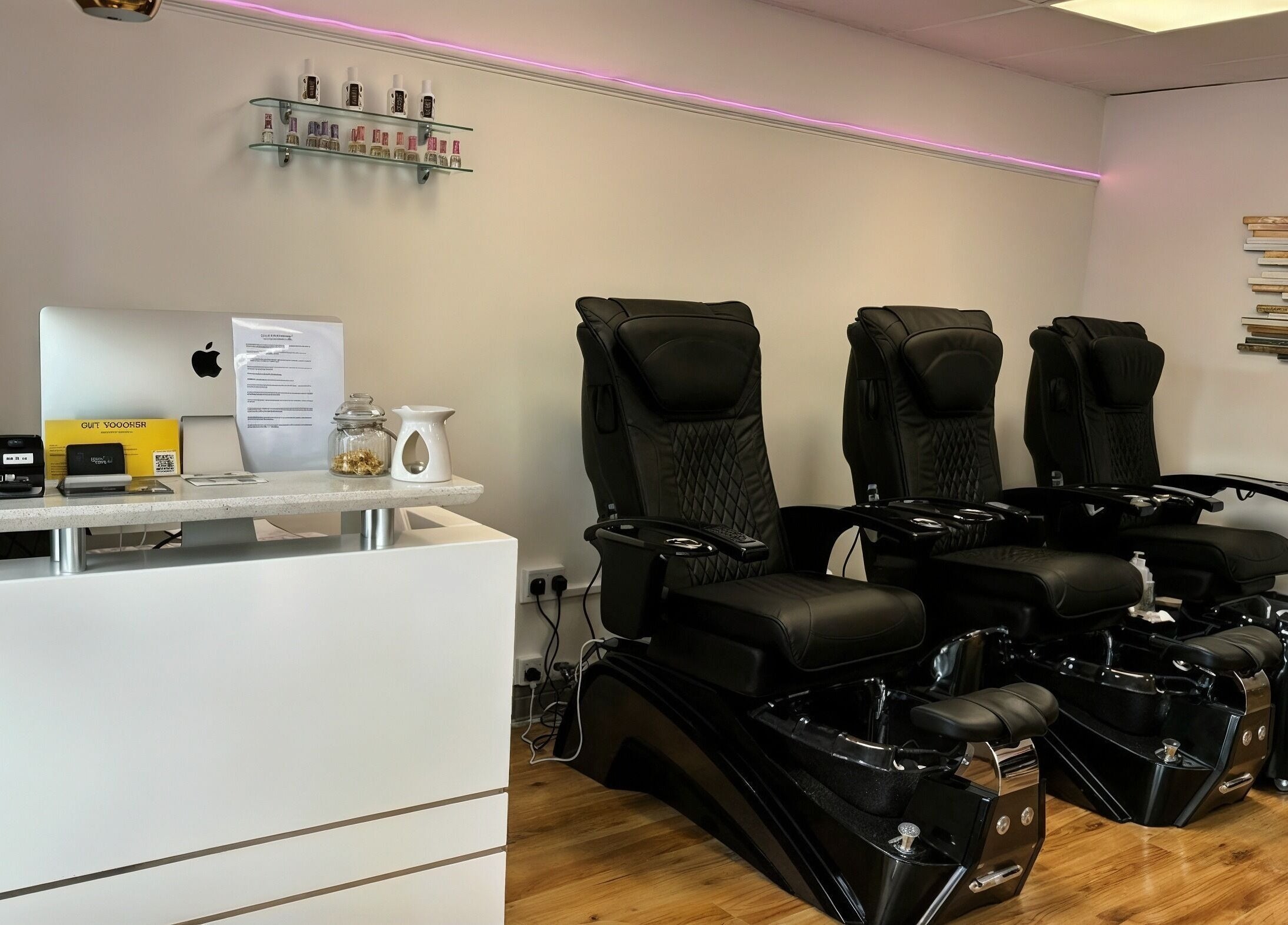 Stylish seating area at Bossy Nails and Beauty Spa in Ennis, County Clare, IE showcasing black pedicure chairs.