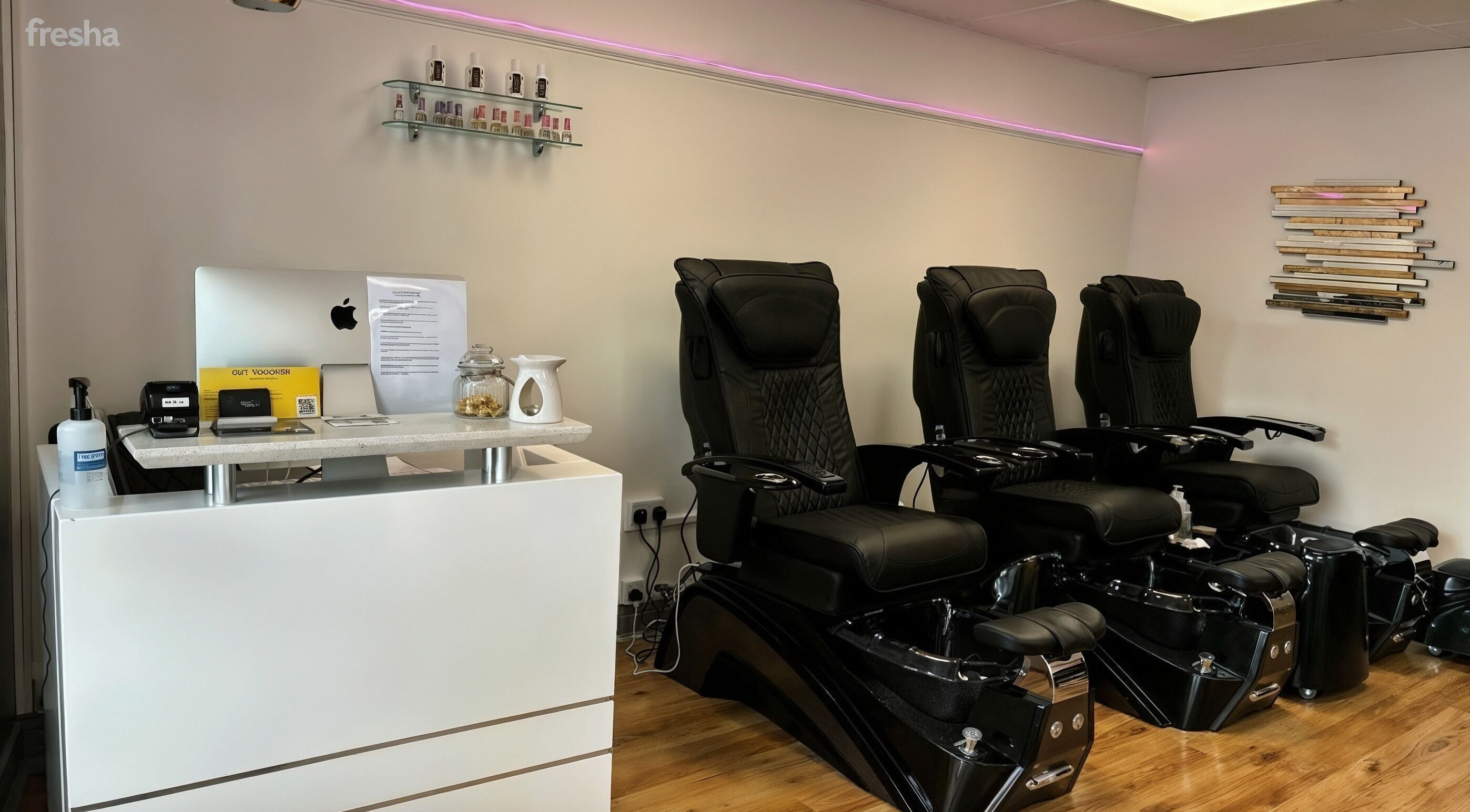 Stylish seating area at Bossy Nails and Beauty Spa in Ennis, County Clare, IE showcasing black pedicure chairs.