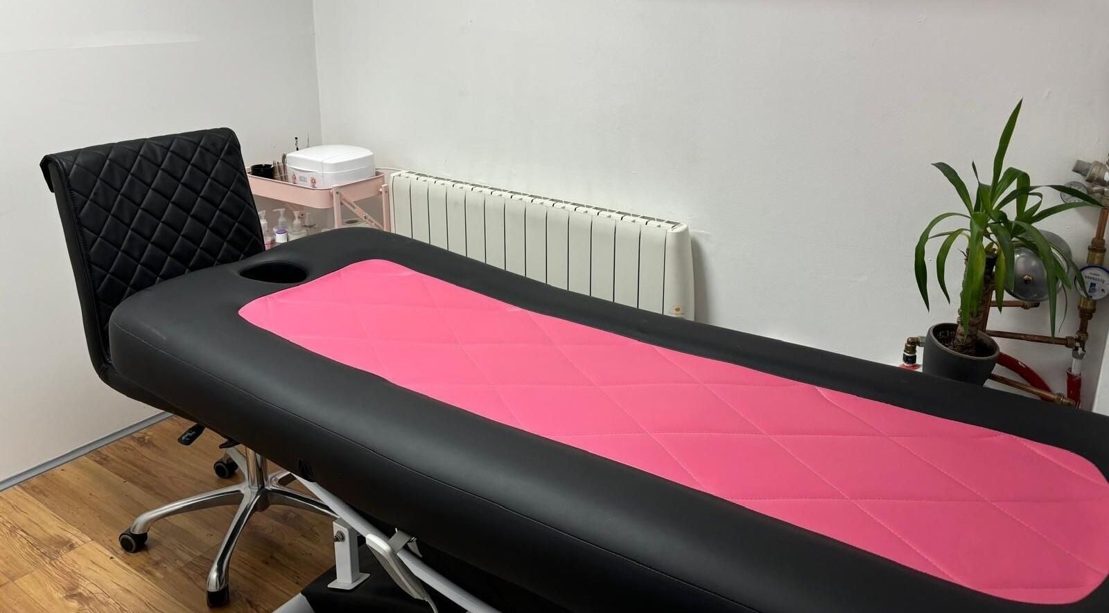 Massage table in pink and black at Bossy Nails and Beauty Spa, Ennis, County Clare, IE. Relaxation awaits.