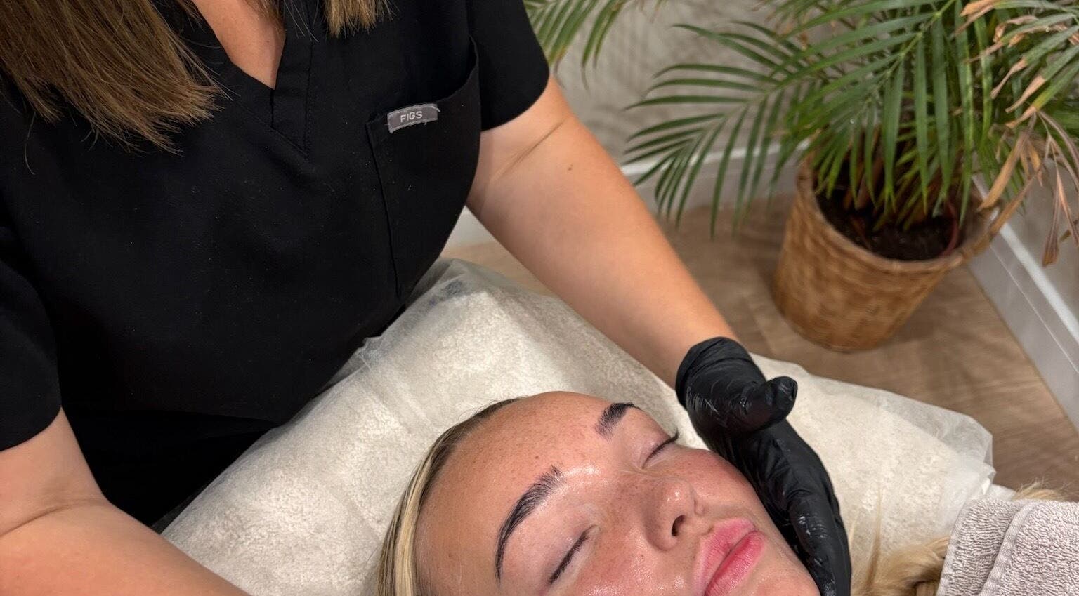 Facial treatment at Haus of Glow @ The Beauty Spot, Sandbach, England, GB. Woman receiving relaxing skincare therapy.