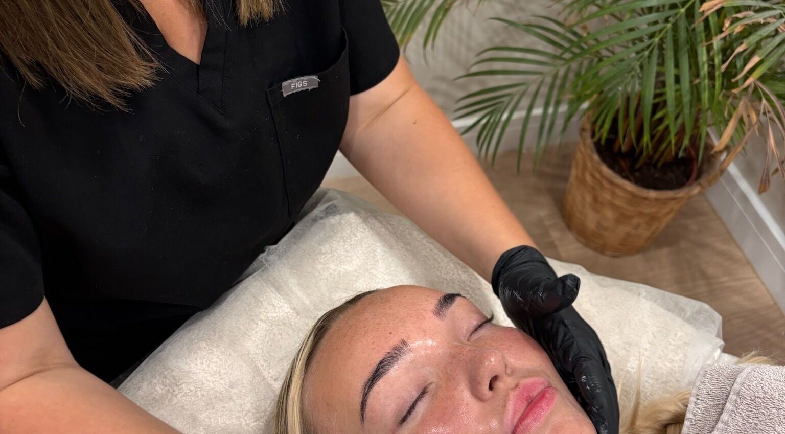 Facial treatment at Haus of Glow @ The Beauty Spot, Sandbach, England, GB. Woman receiving relaxing skincare therapy.